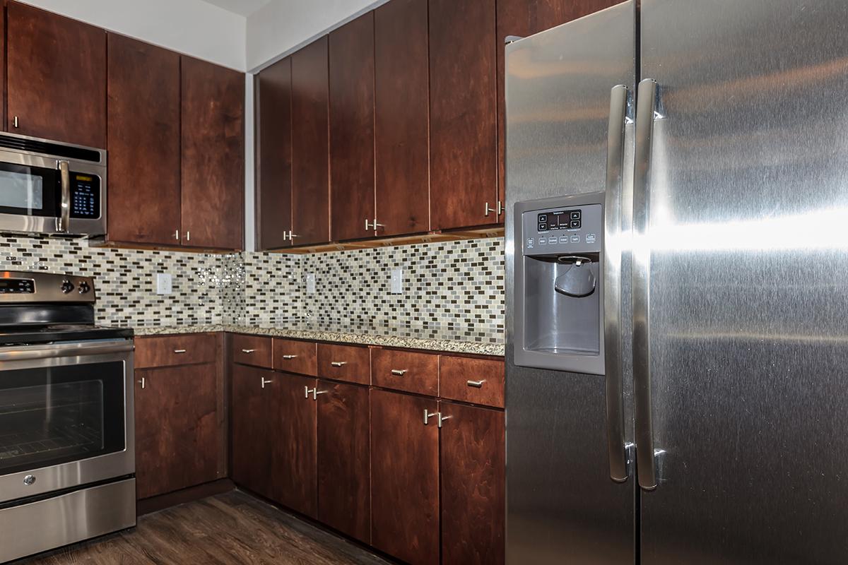 a kitchen with stainless steel appliances and wooden cabinets