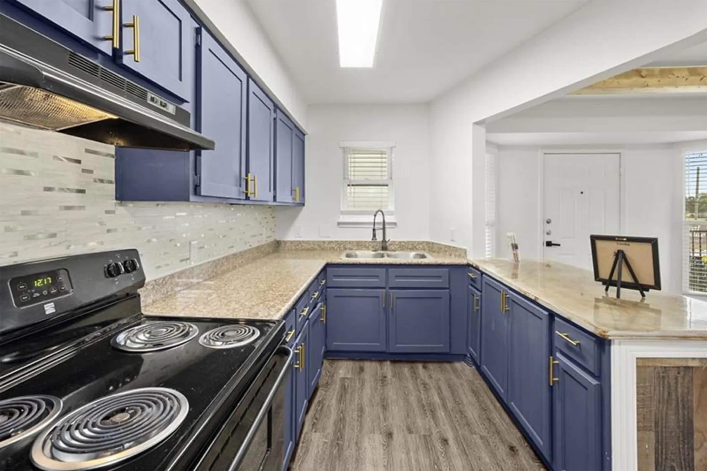 a stove top oven sitting inside of a kitchen