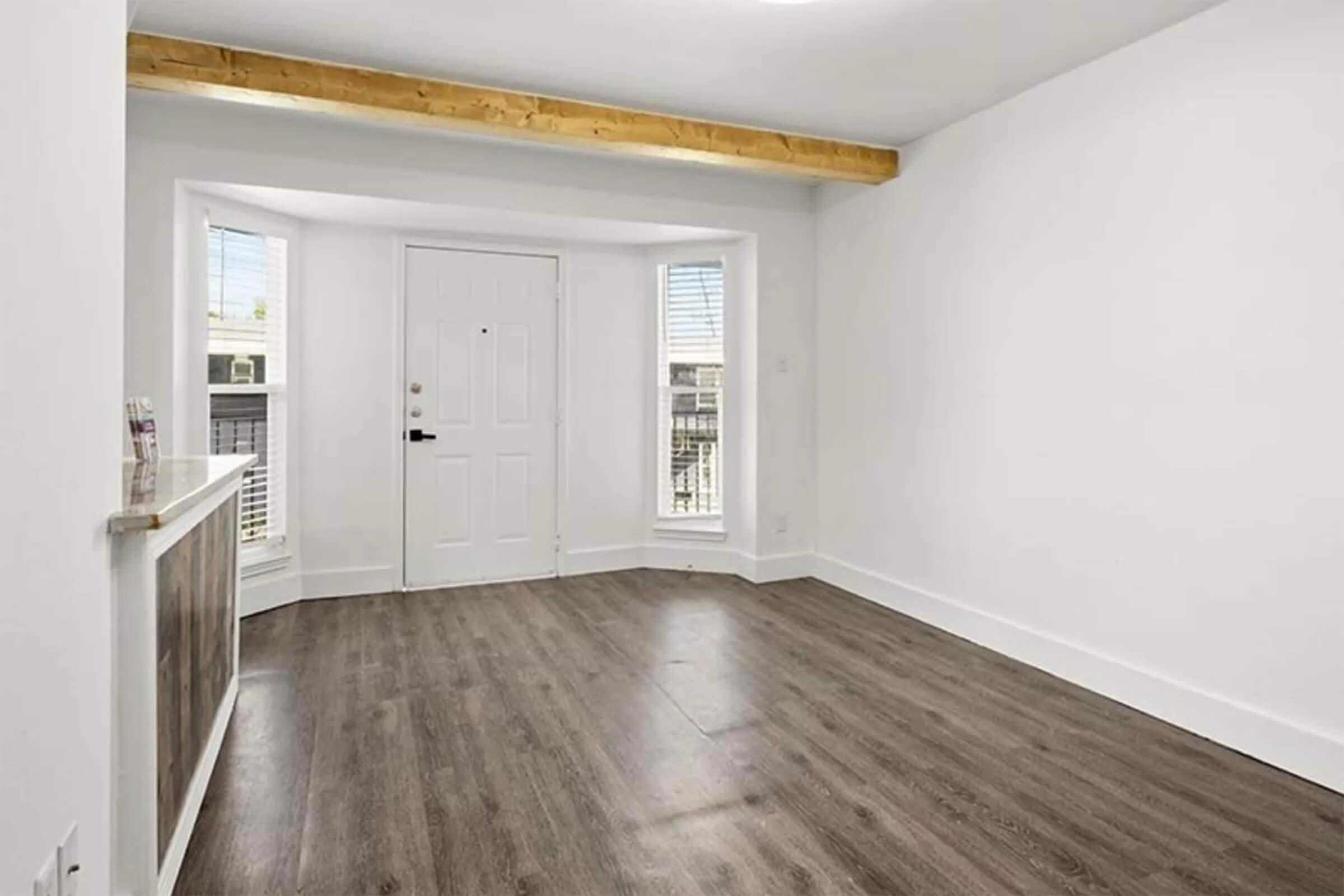 a large empty room with a wooden floor