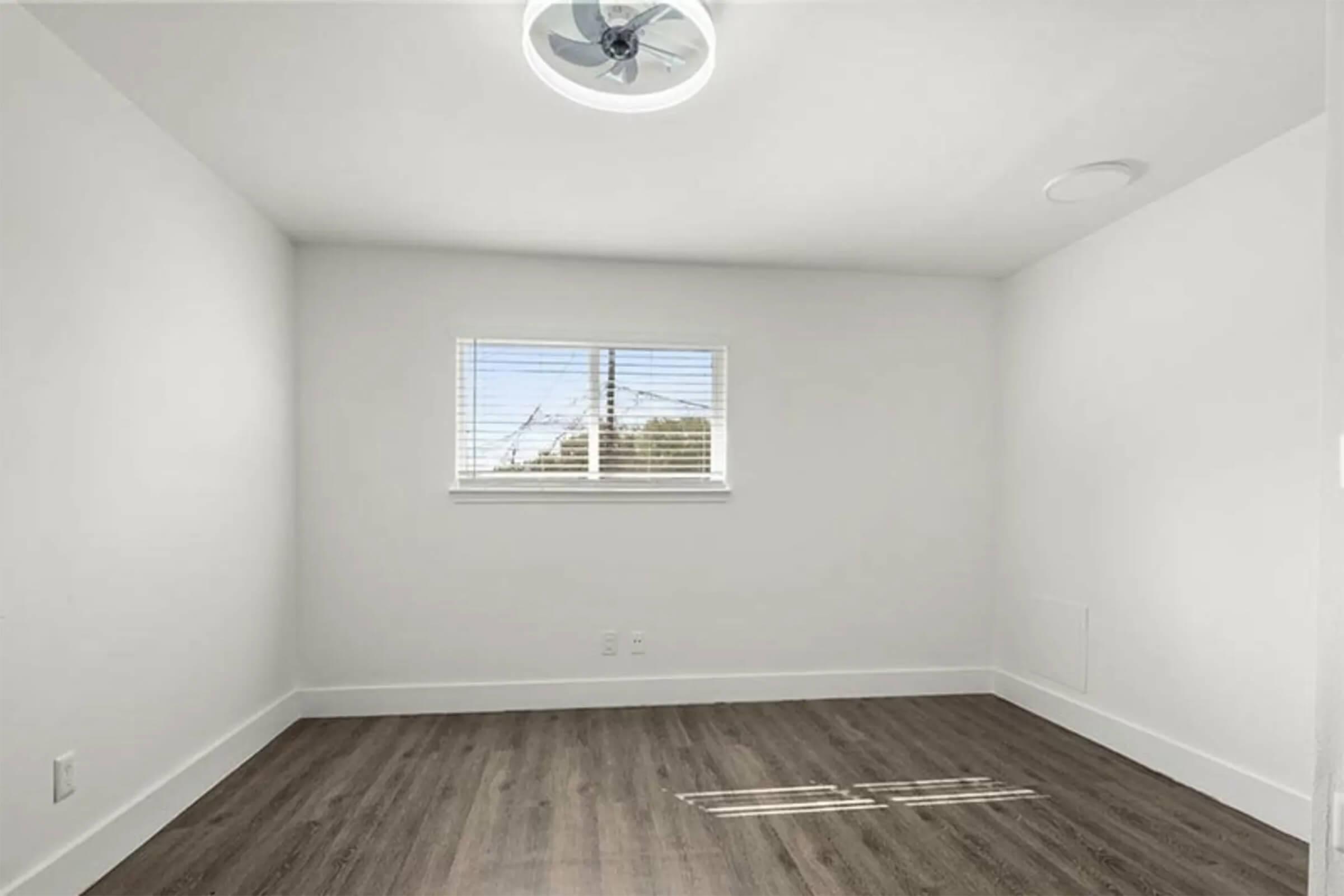 a large empty room with a wood floor