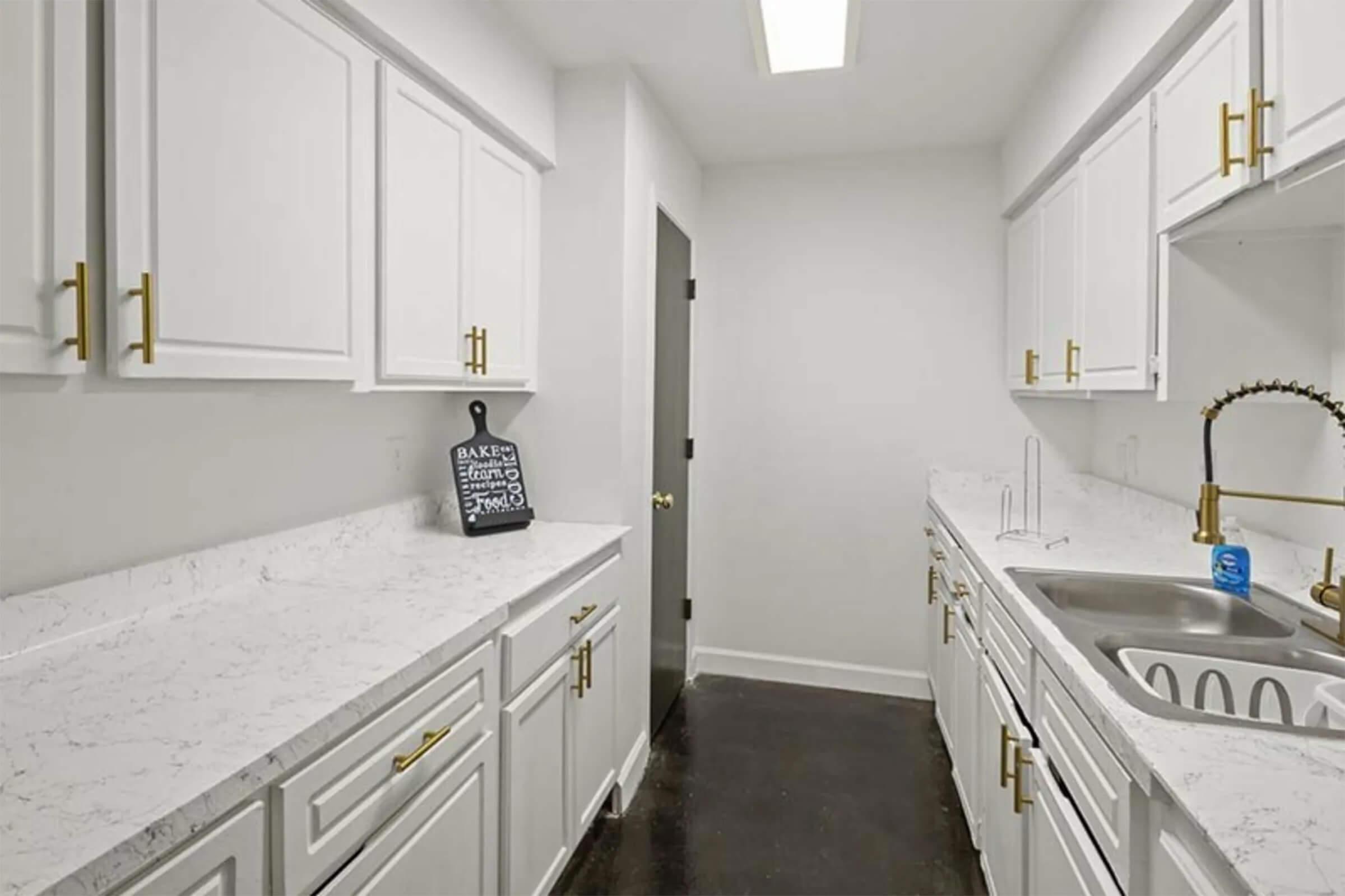 a kitchen with a sink and a mirror