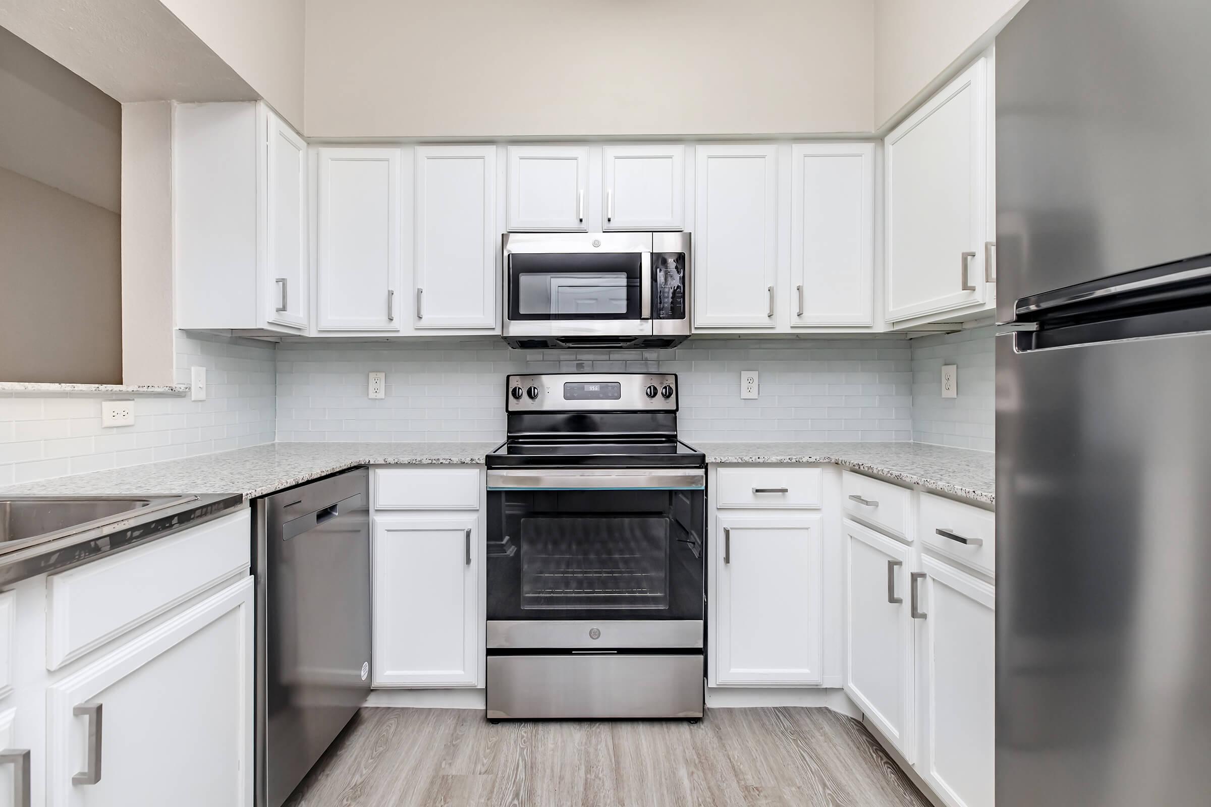 a stove top oven sitting inside of a kitchen