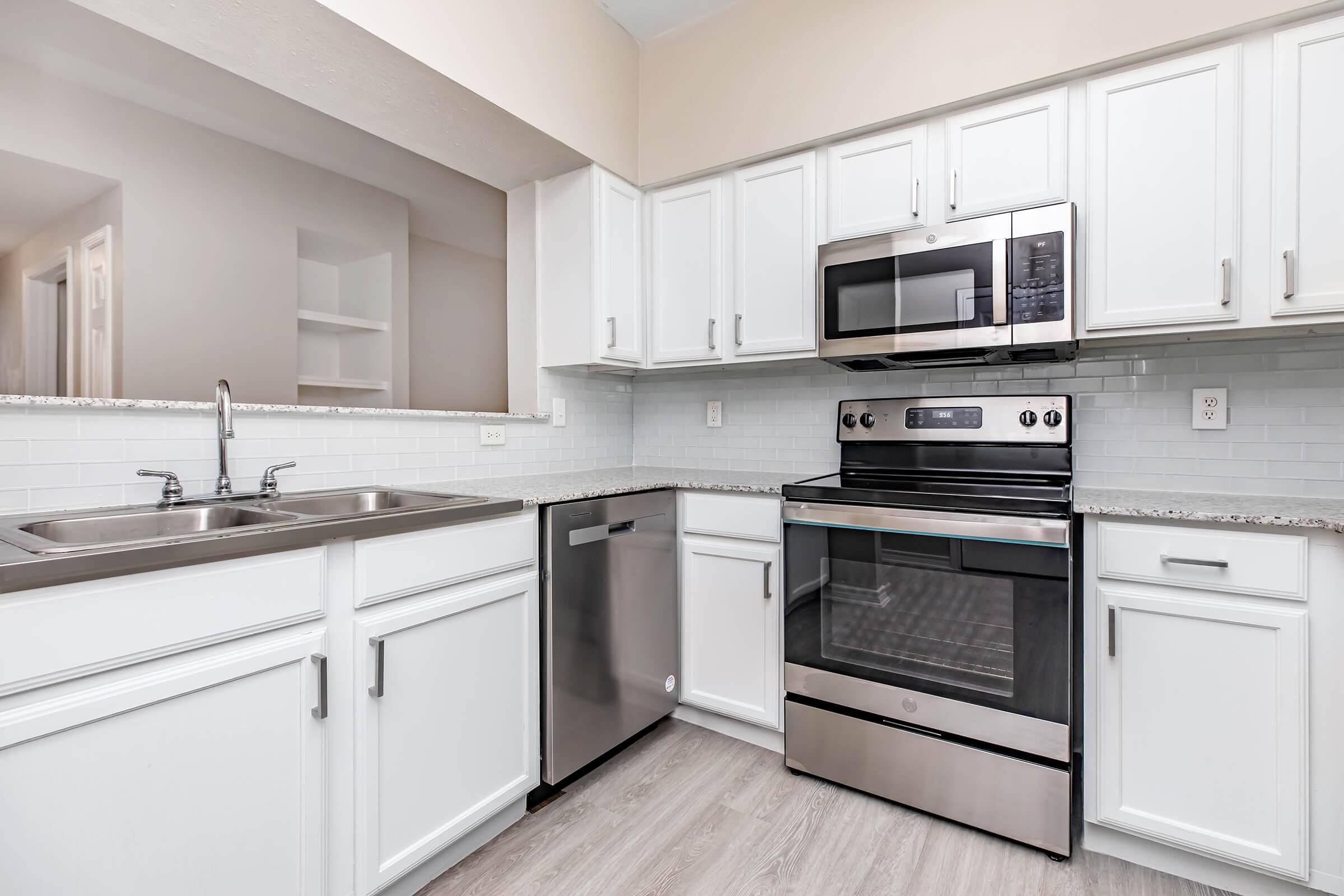 a kitchen with a stove sink and refrigerator