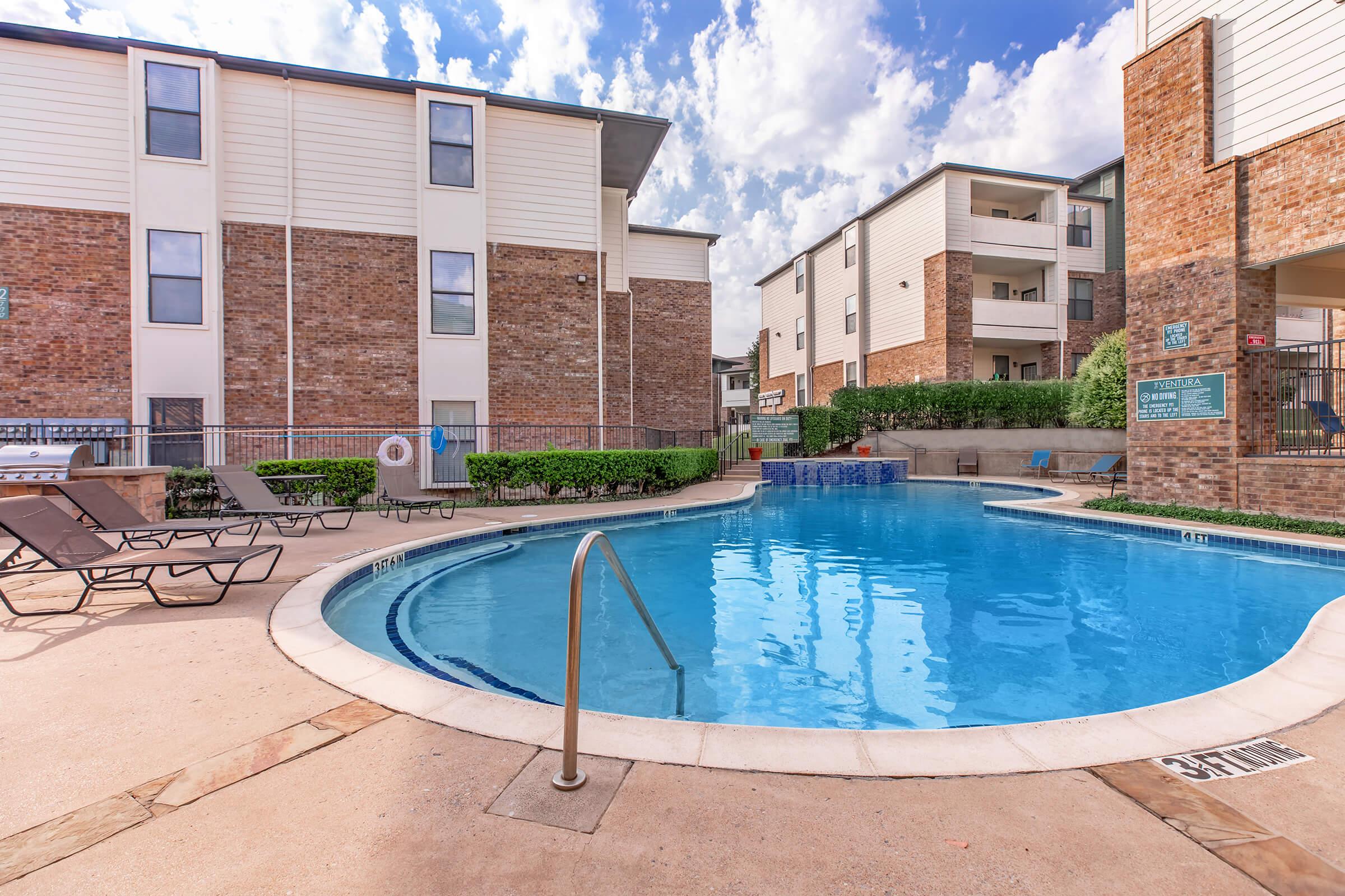 a pool next to a brick building