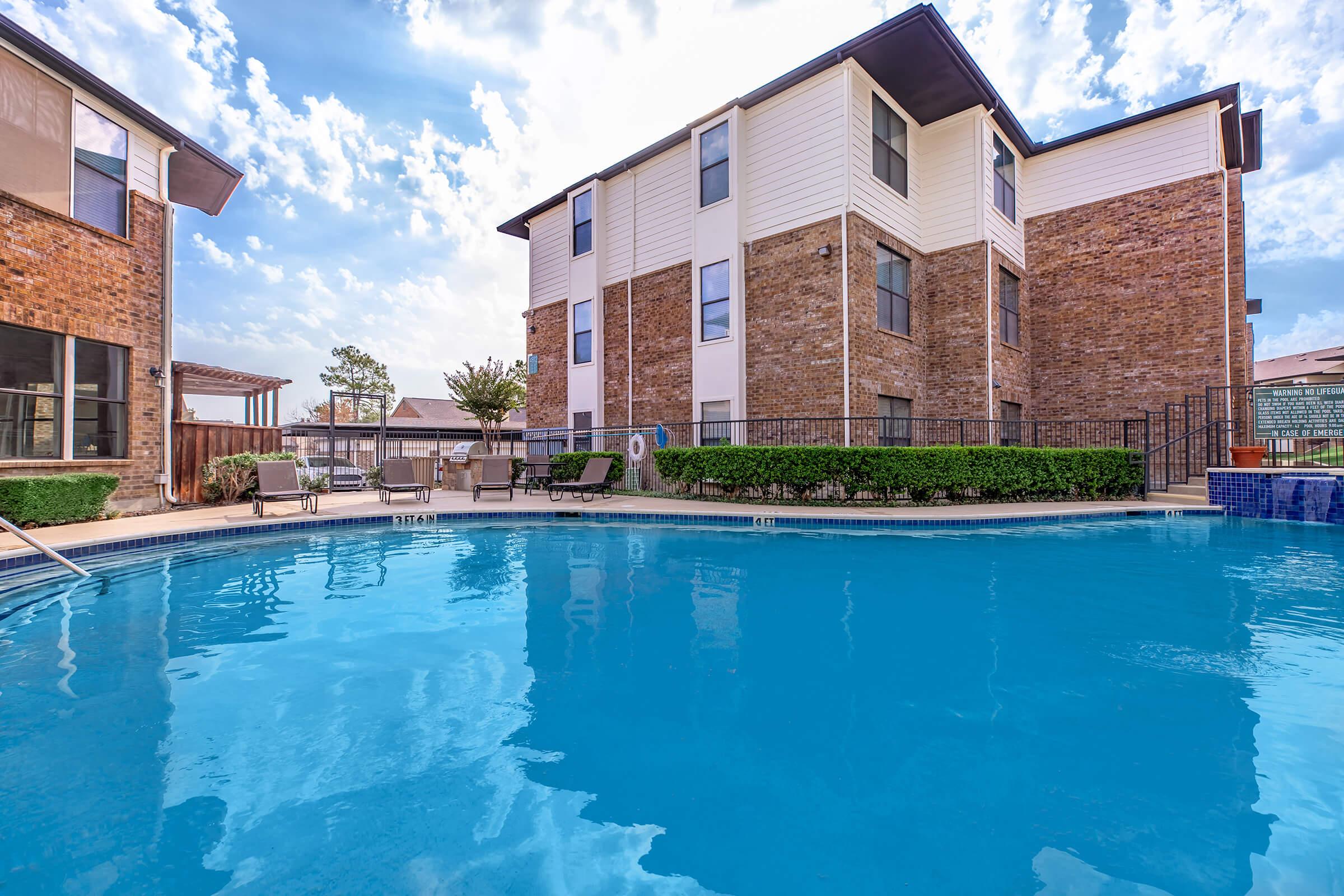 a large pool of water in front of a house