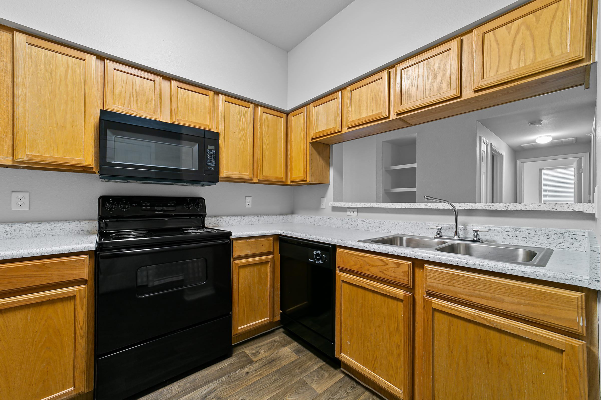 a kitchen with stainless steel appliances and wooden cabinets