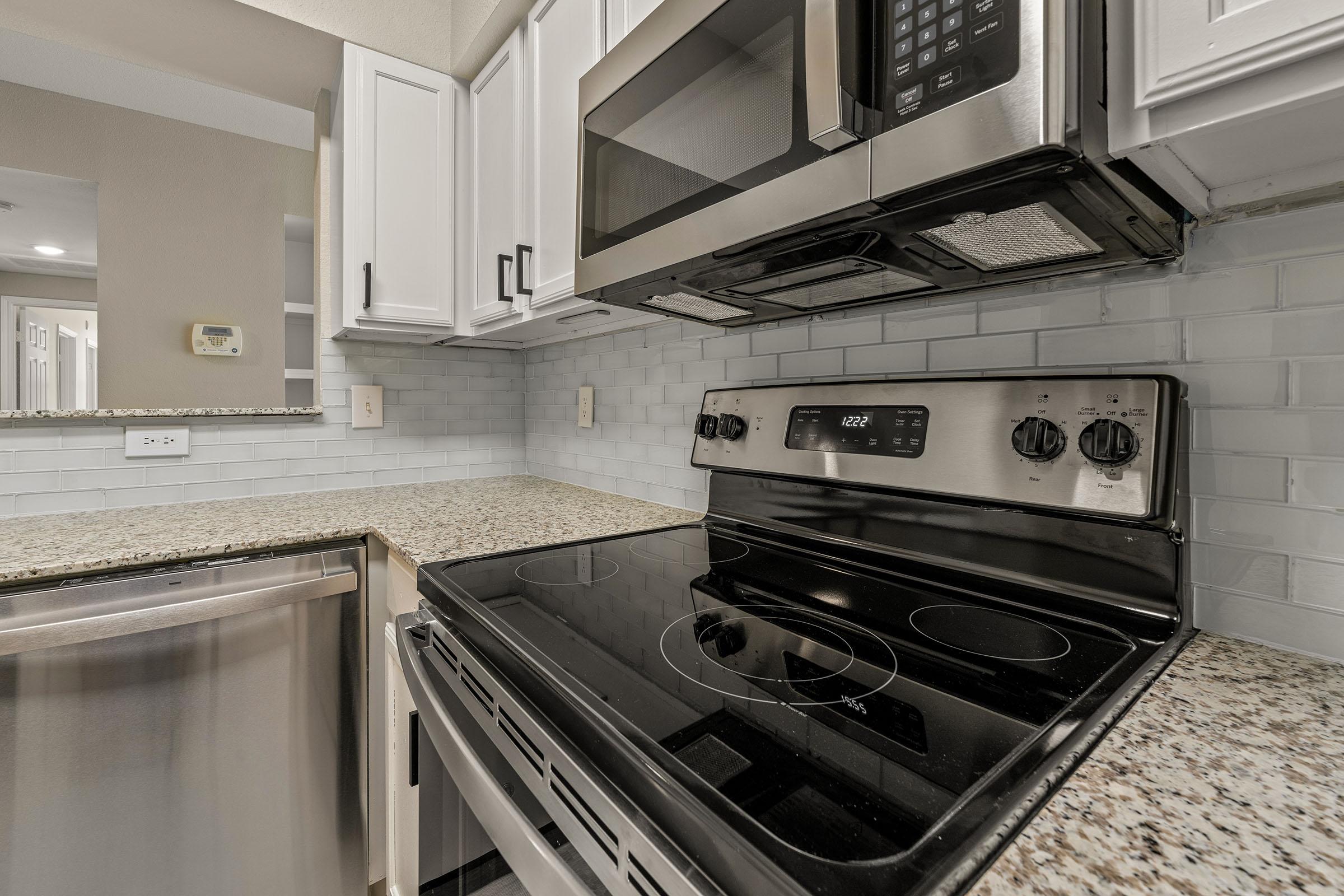 a stove top oven sitting inside of a kitchen