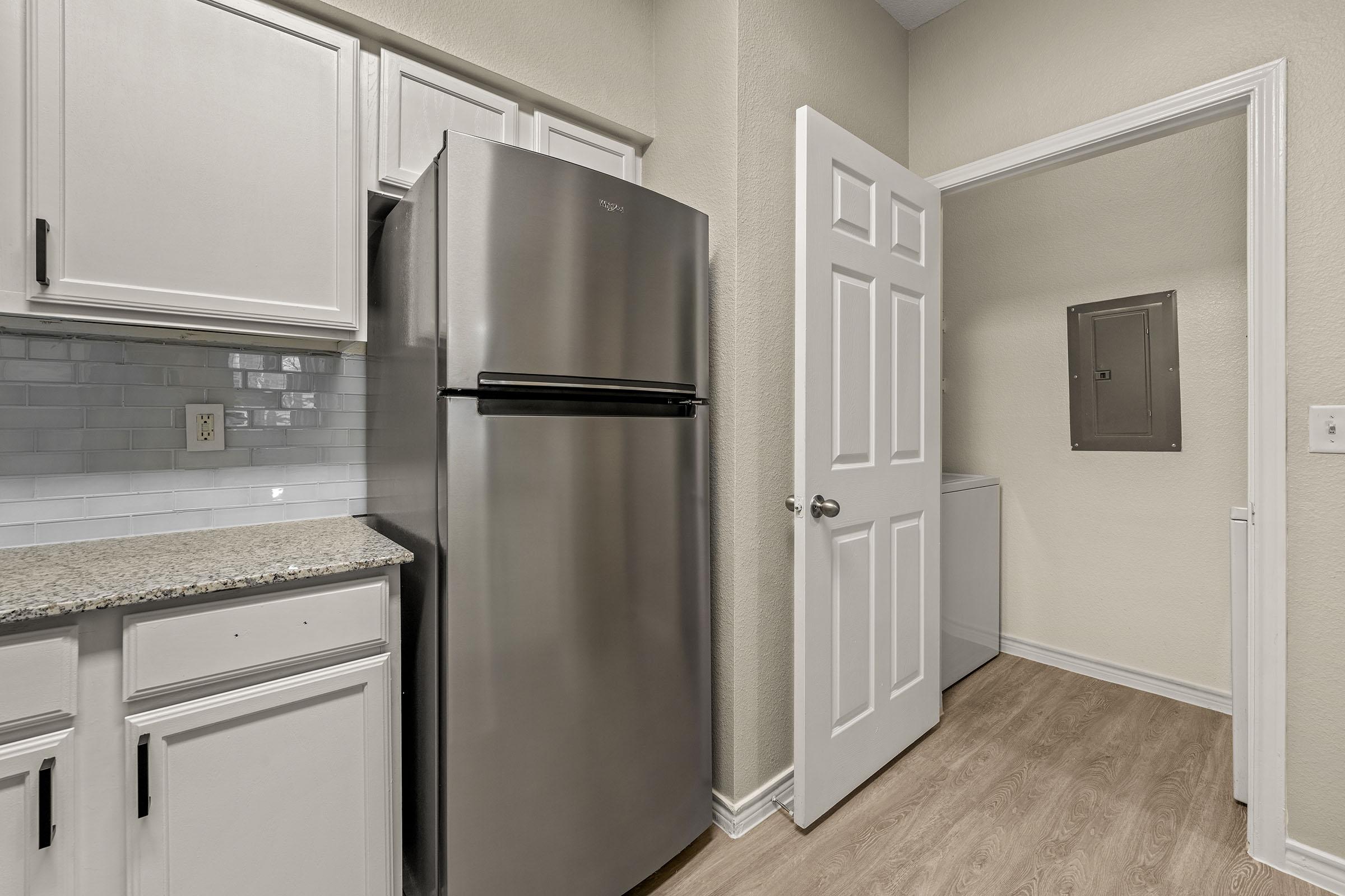 a kitchen with a sink and a refrigerator