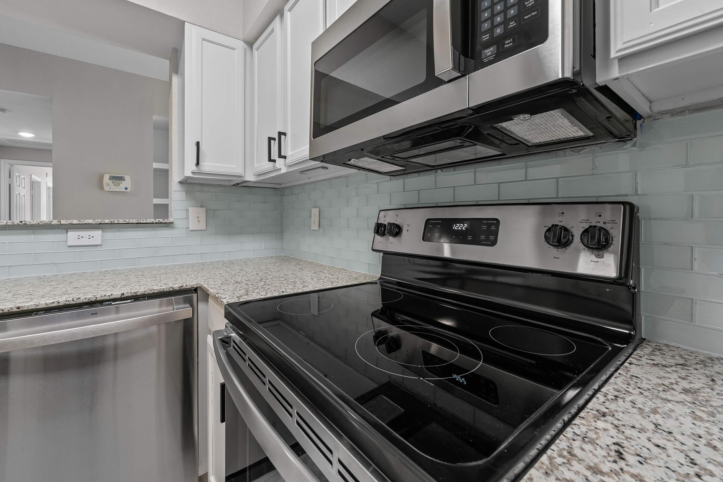 a stove top oven sitting inside of a kitchen