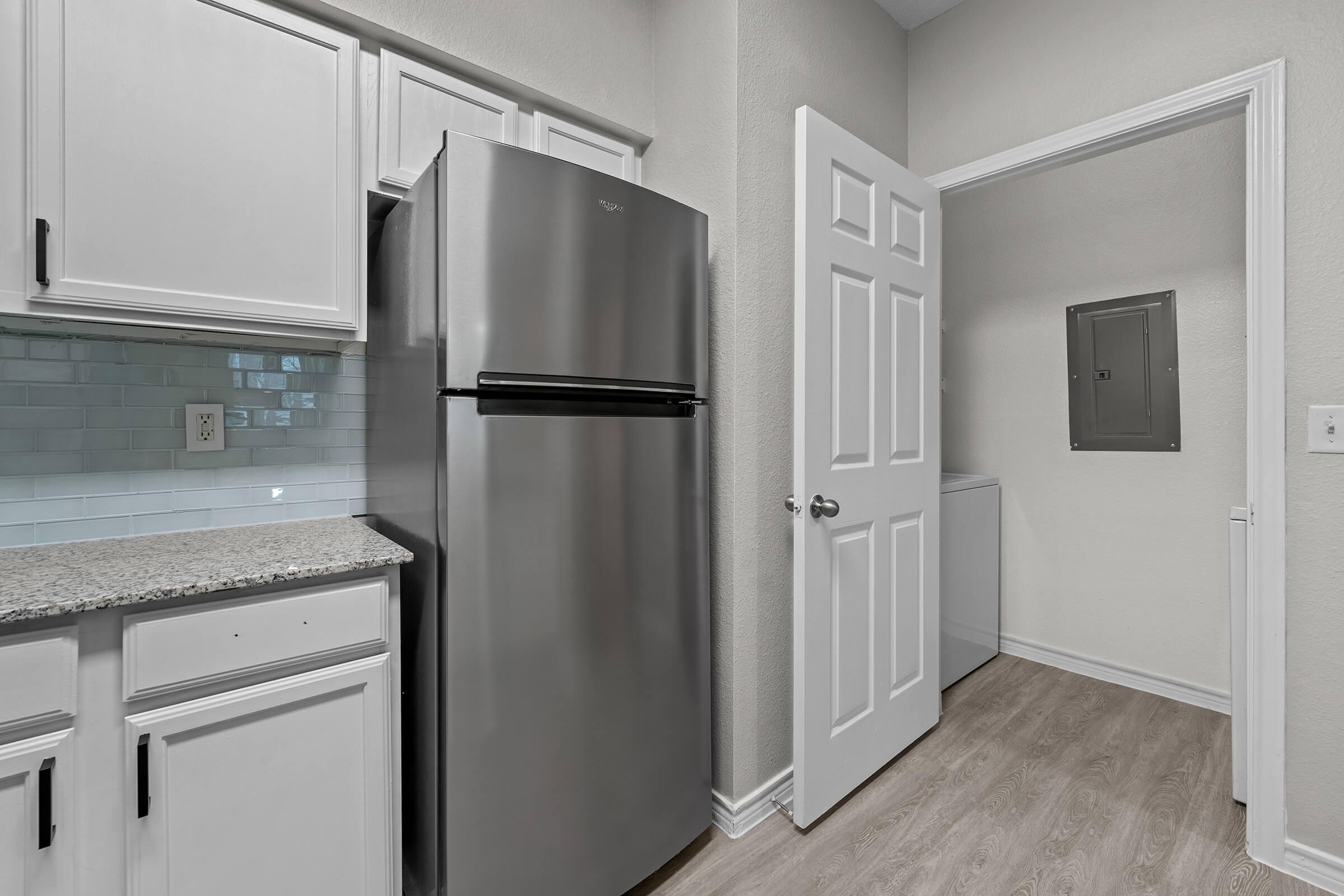 a kitchen with a sink and a refrigerator