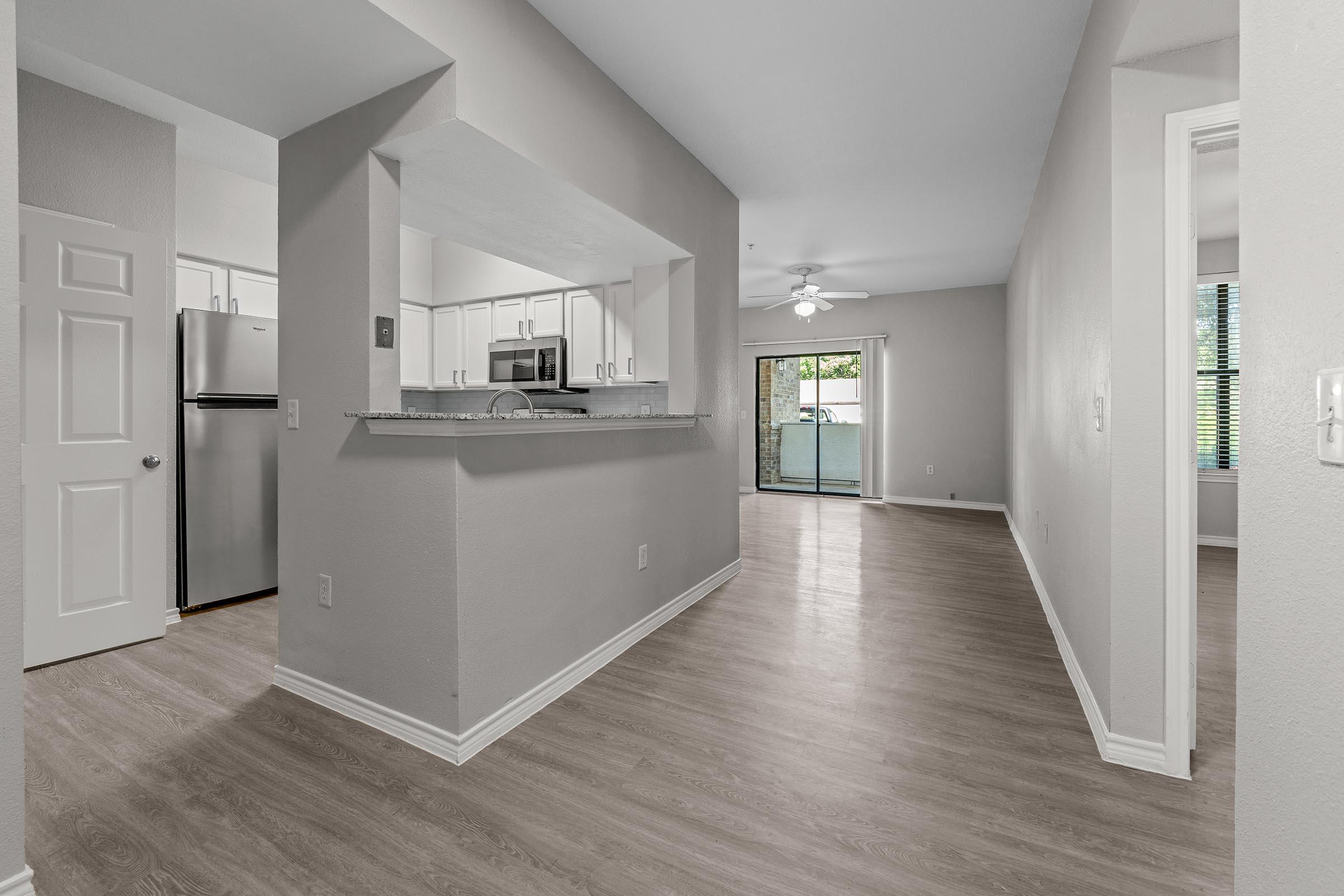 a kitchen area with a building in the background