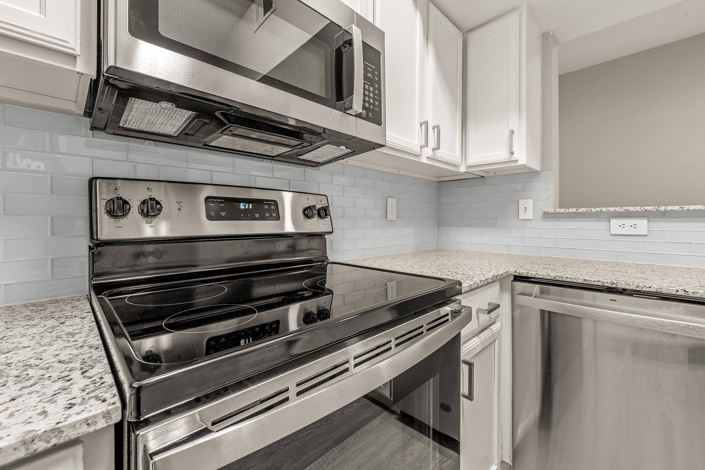 a stove top oven sitting inside of a kitchen