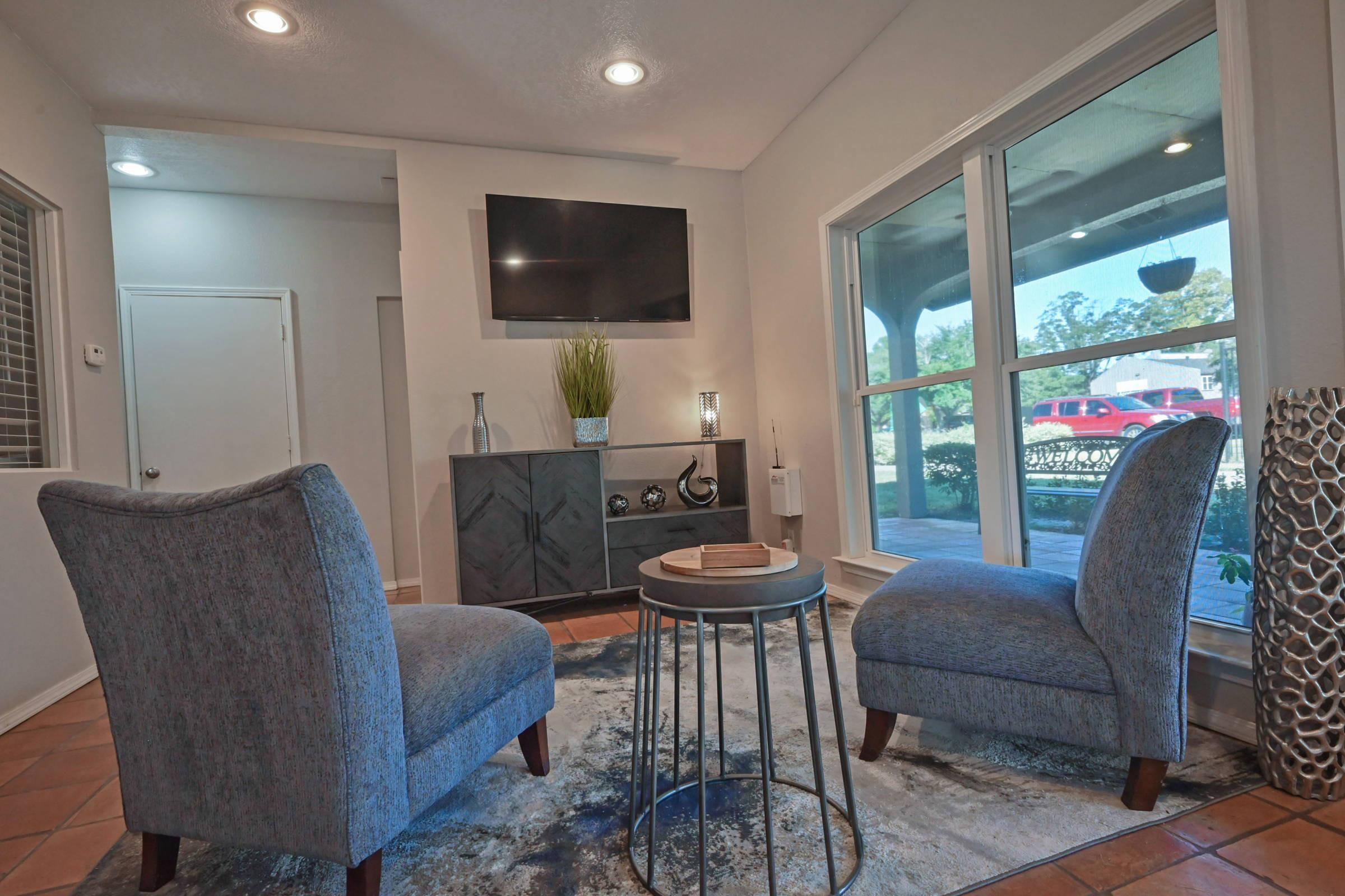 a living room filled with furniture and a large window