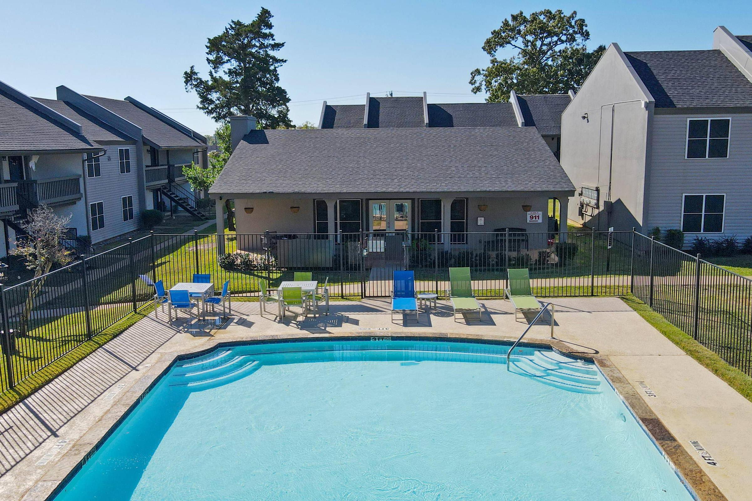 a house with a pool in front of a building