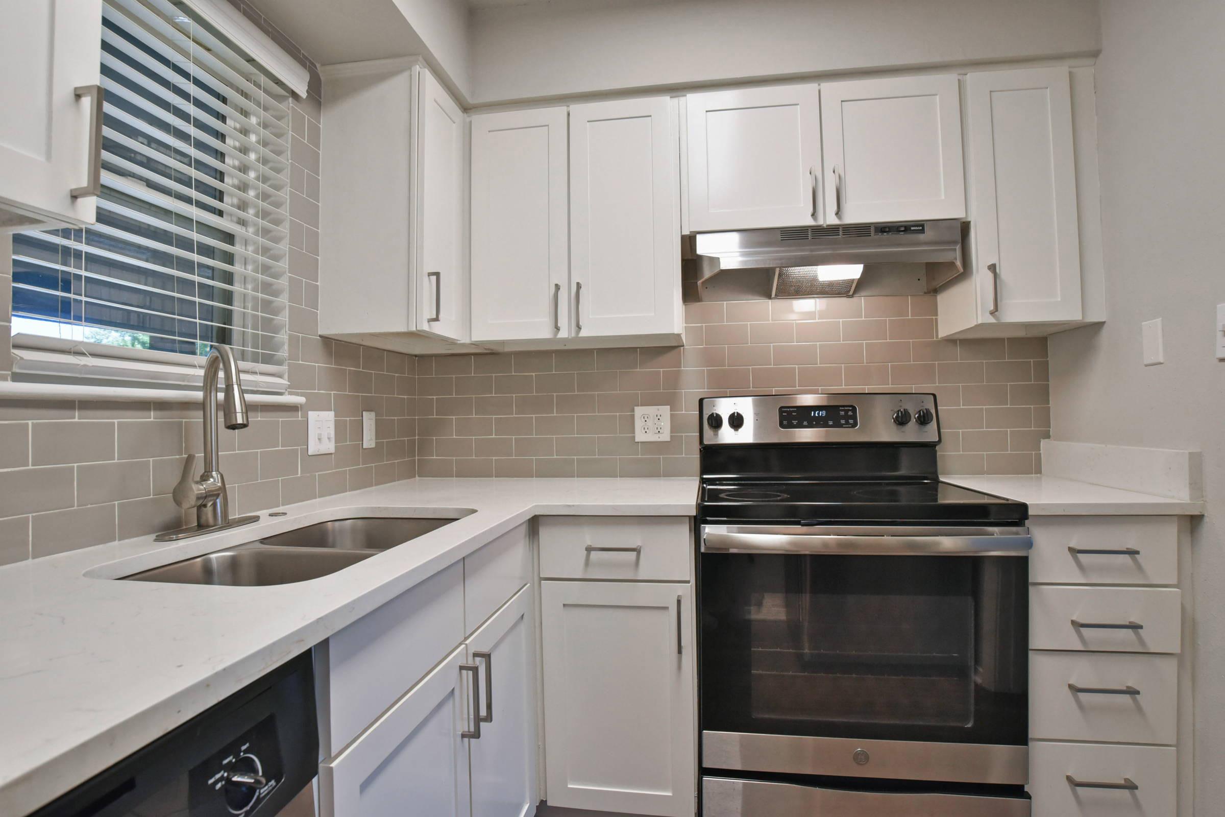 a stove top oven sitting inside of a kitchen