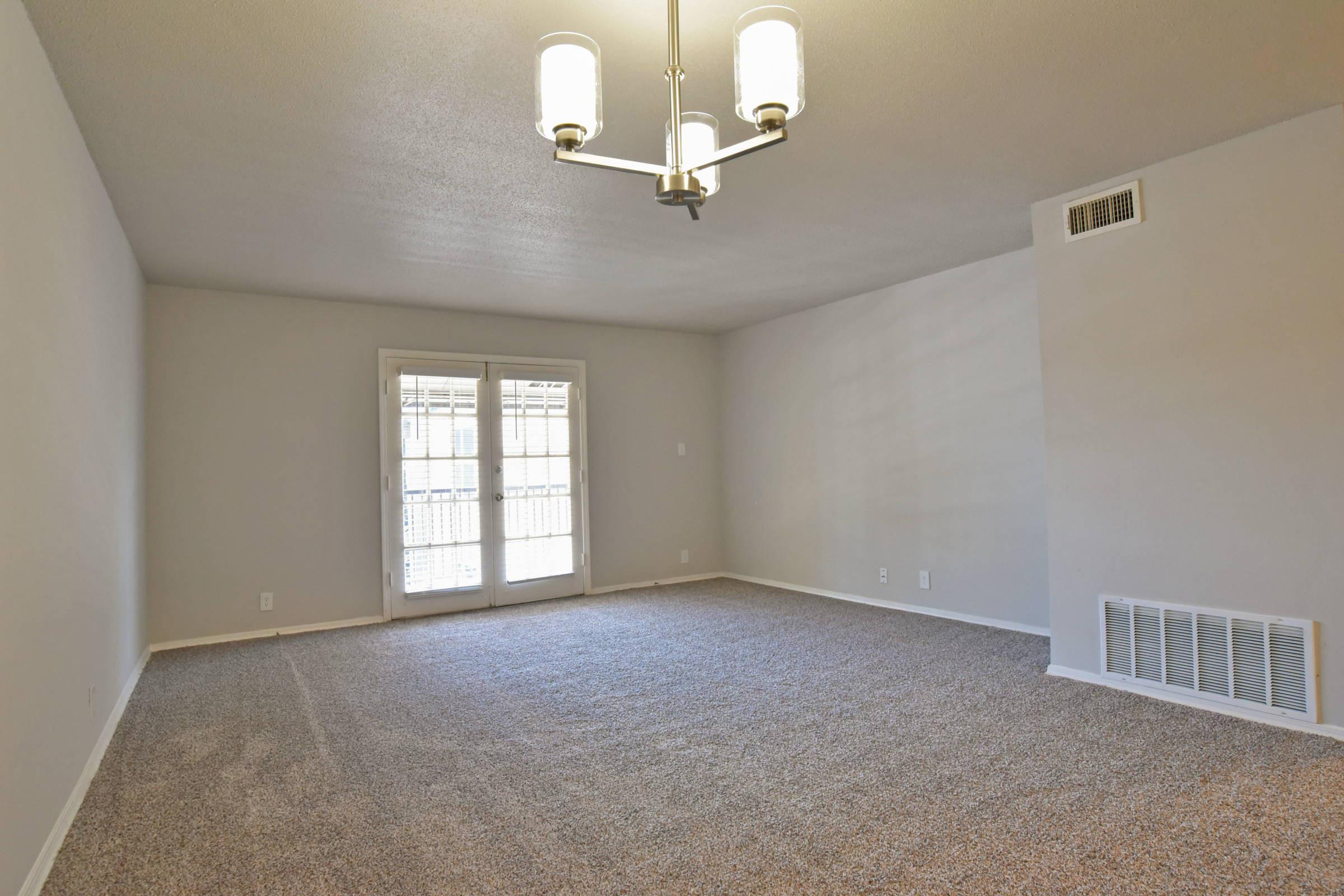 a large empty room with a sink and a mirror