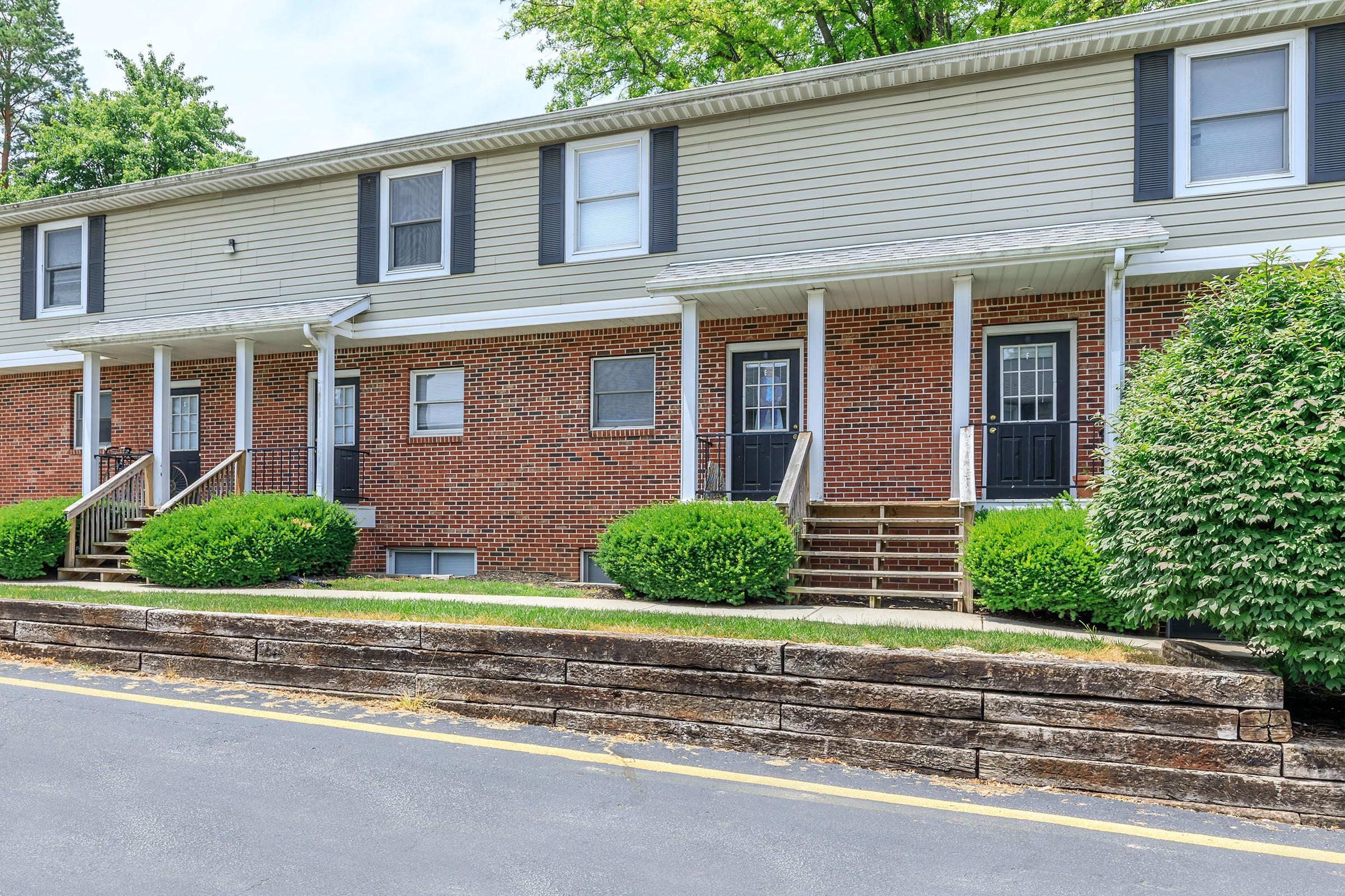 a house with bushes in front of a building