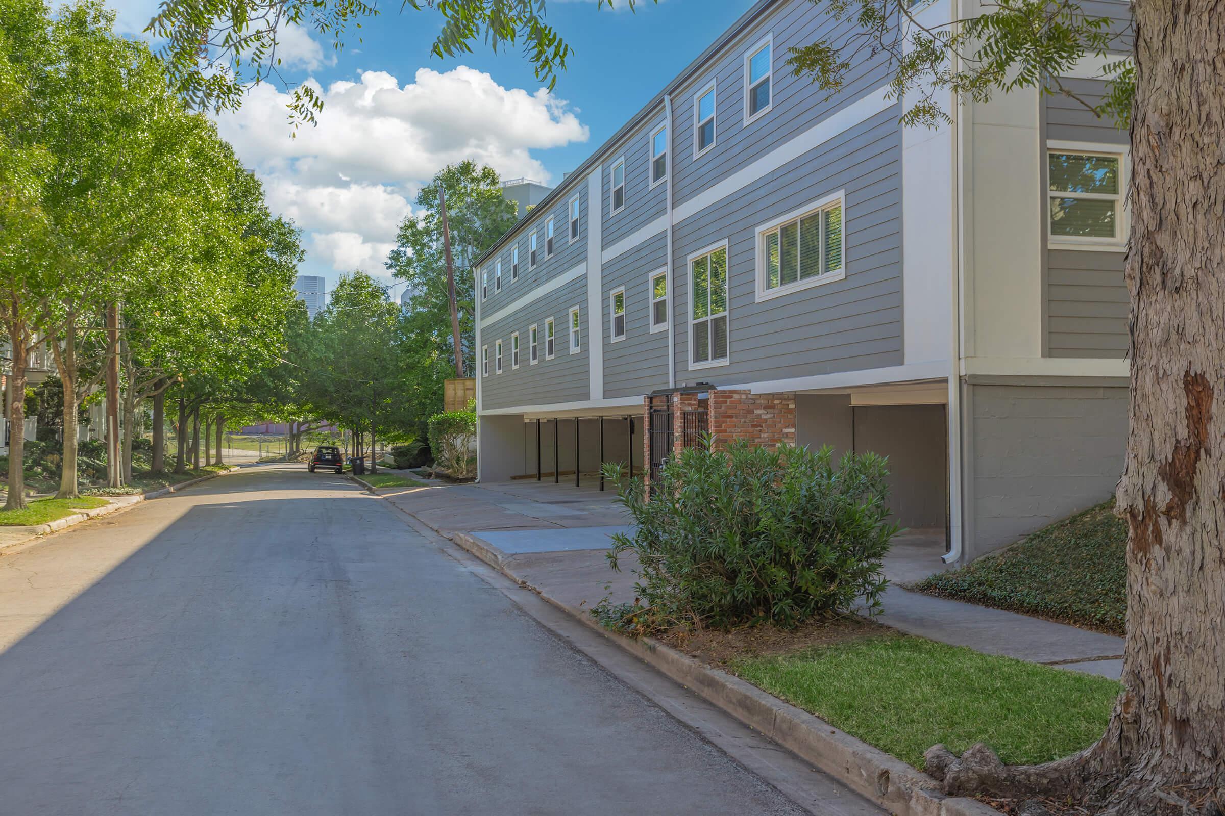 a path with trees on the side of a building