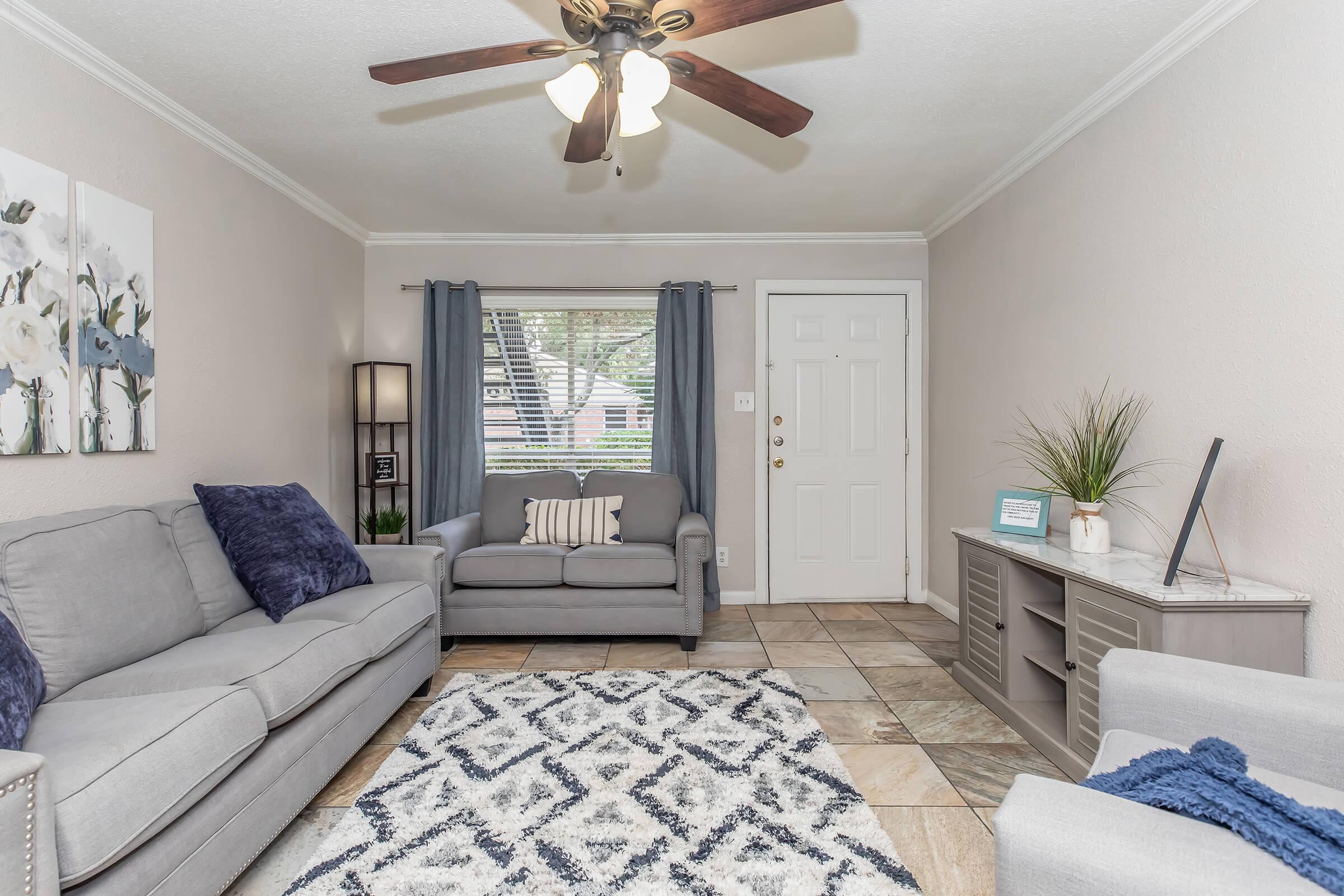 a bedroom with a bed and a couch in a living room