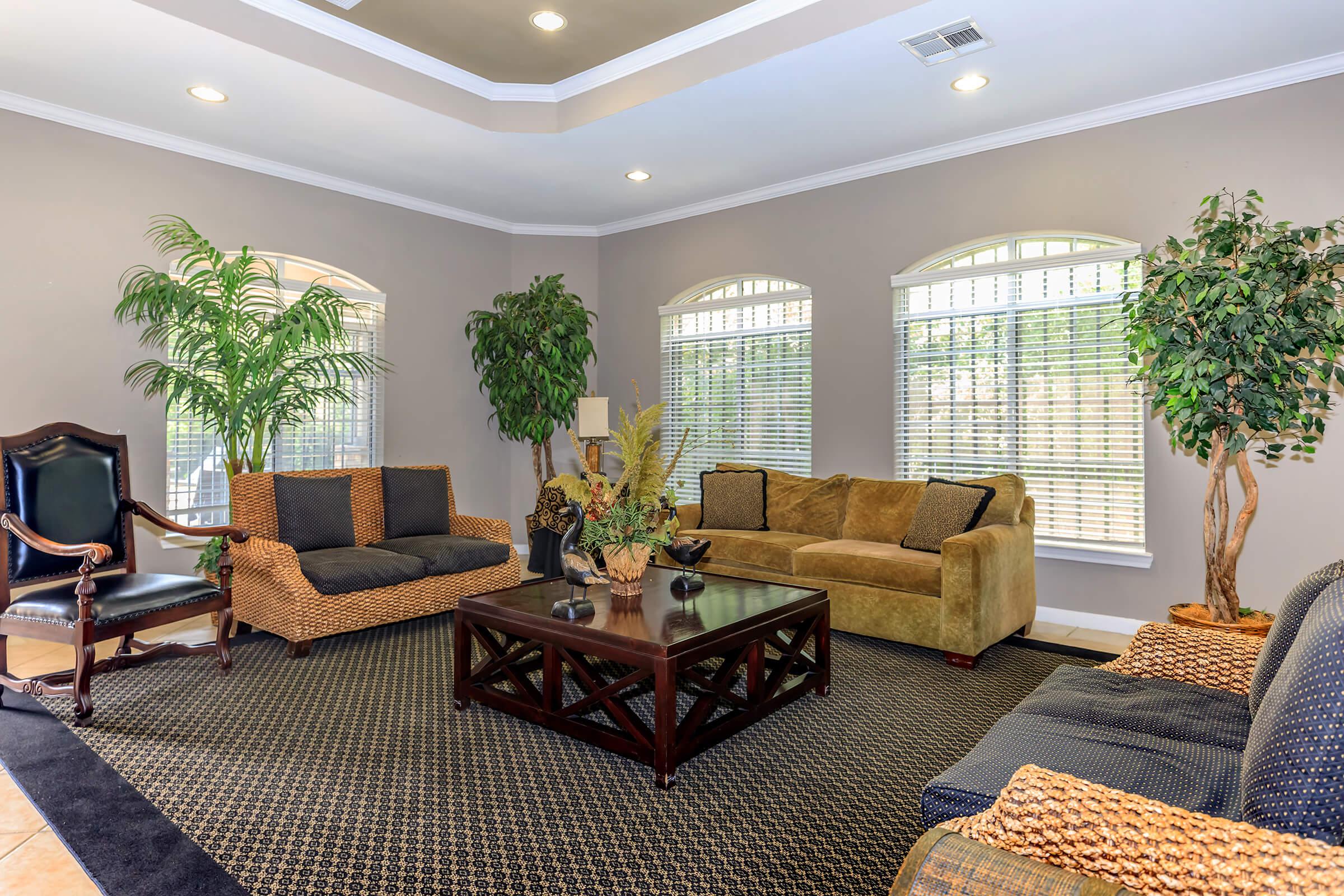 a living room filled with furniture and a large window