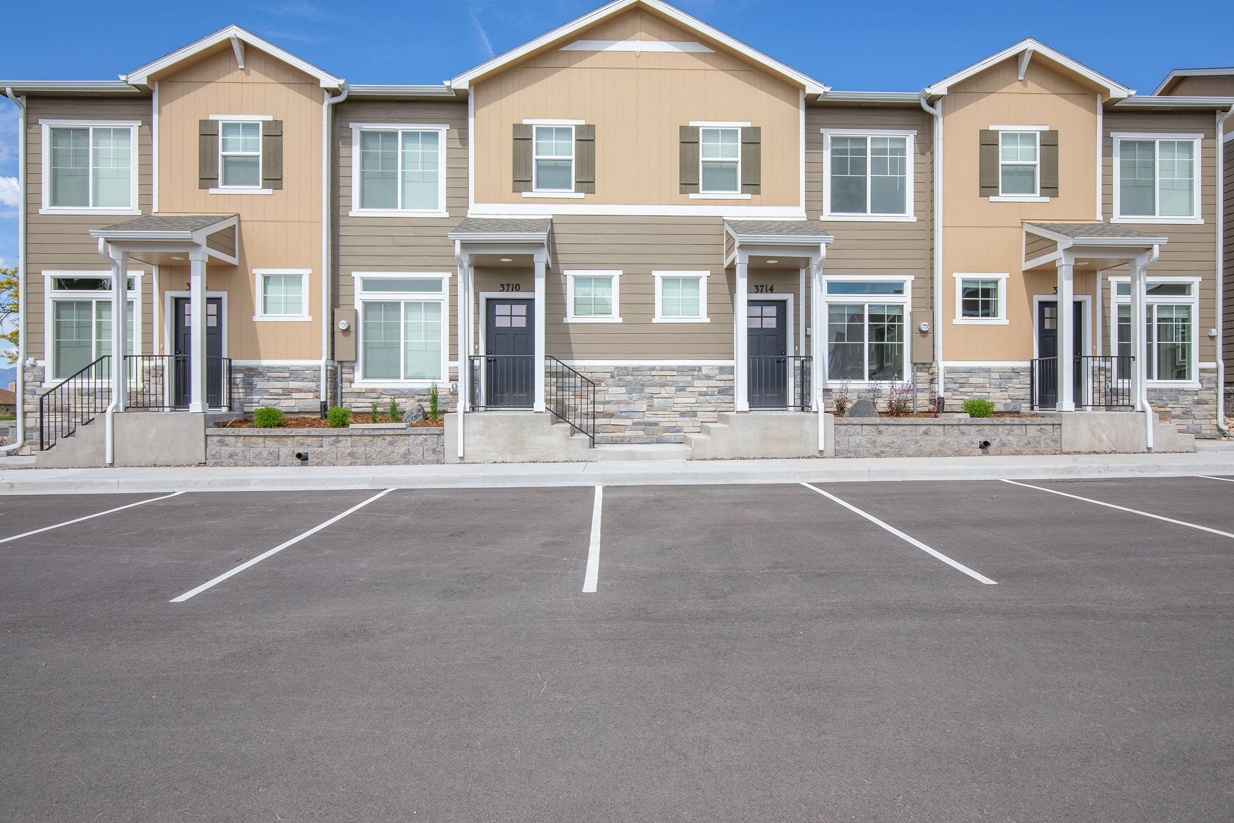 an empty parking lot in front of a house