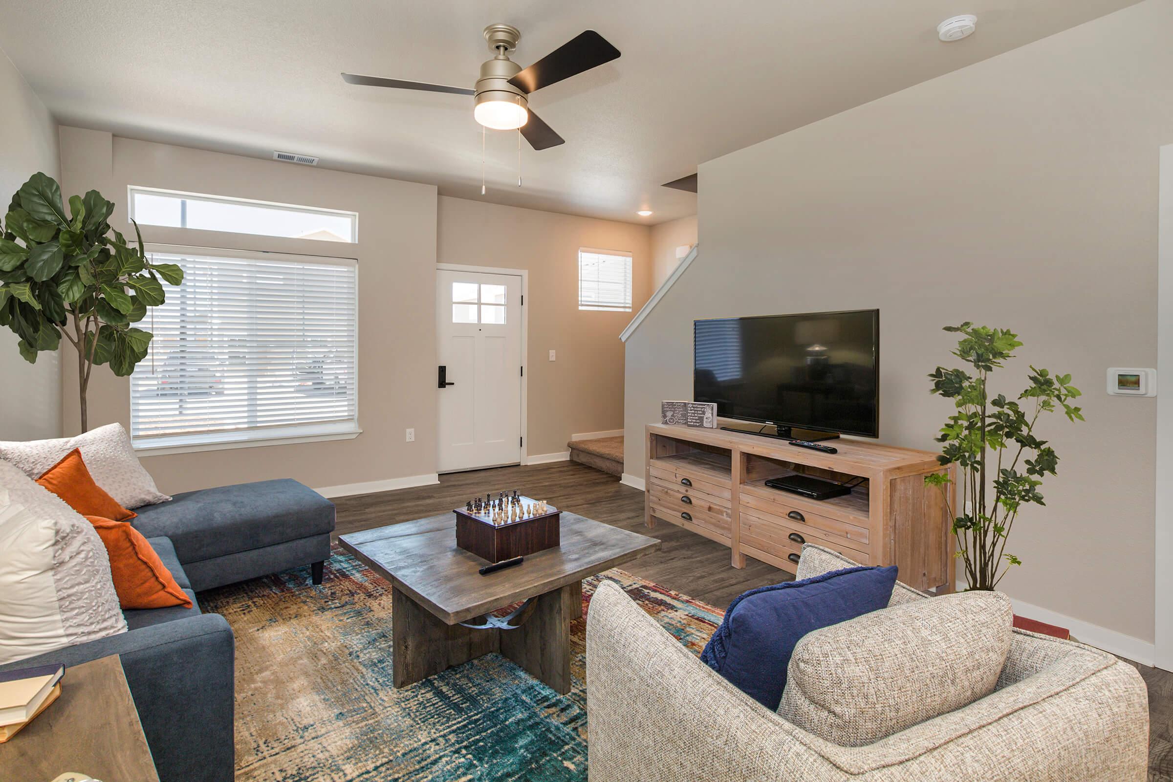 a living room filled with furniture and a flat screen tv