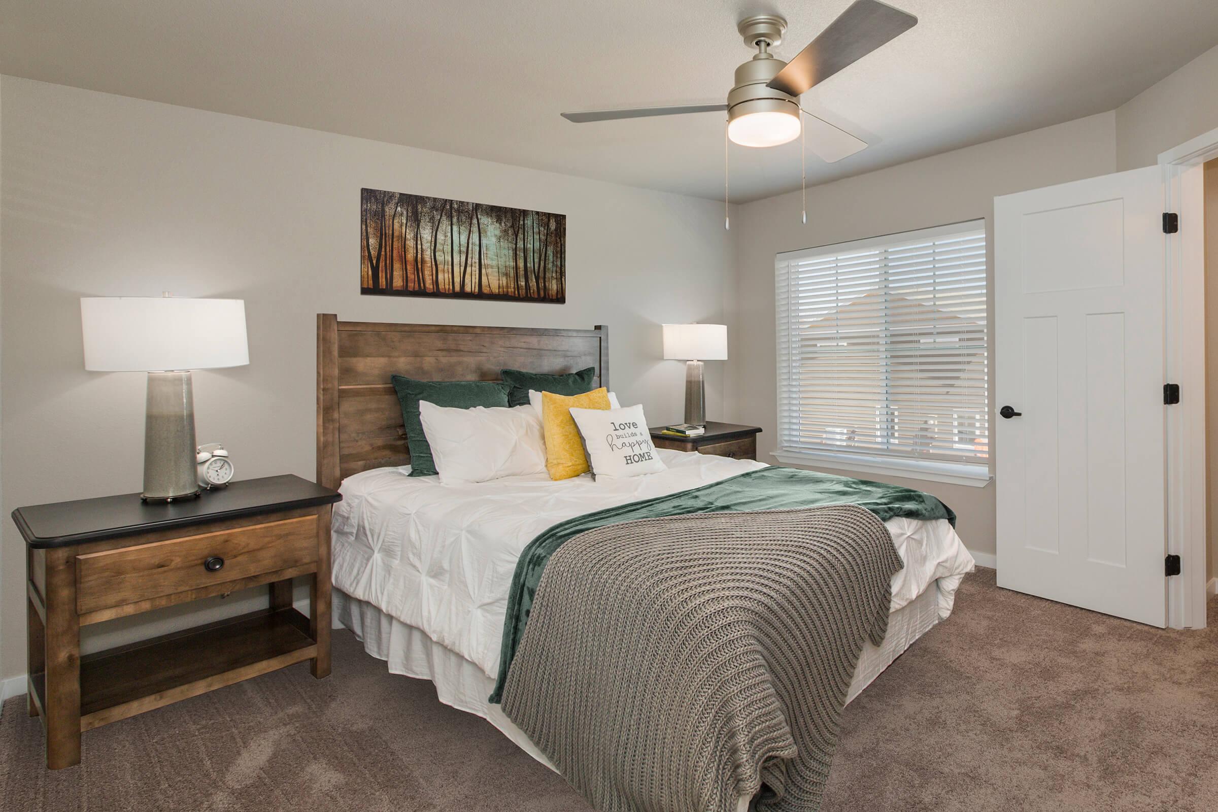 a bedroom with a bed and desk in a room