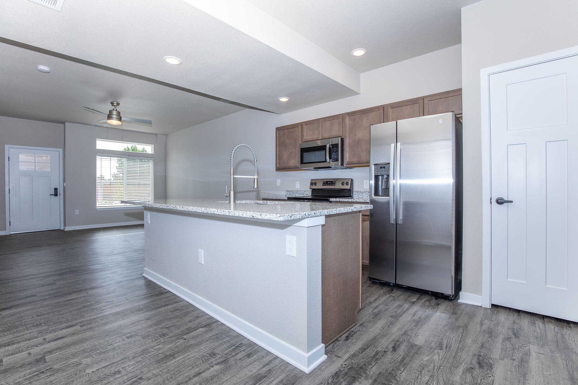 a large kitchen with stainless steel appliances