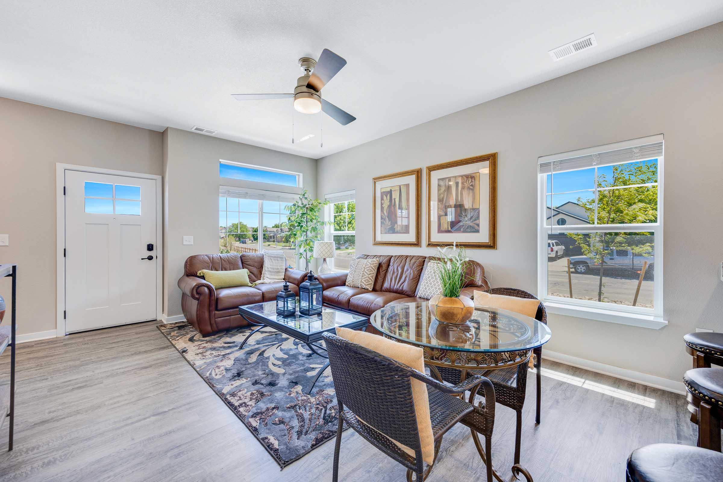 a living room filled with furniture and a large window