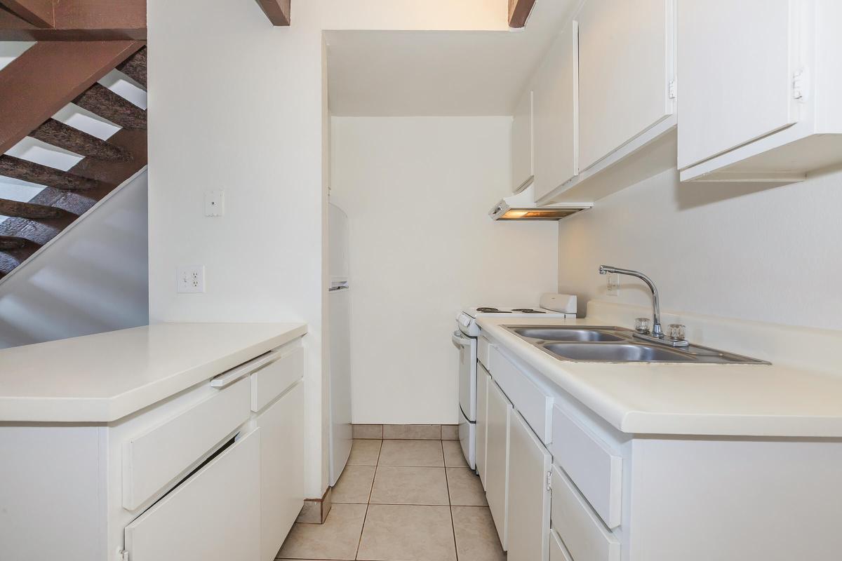 a white stove top oven sitting inside of a kitchen