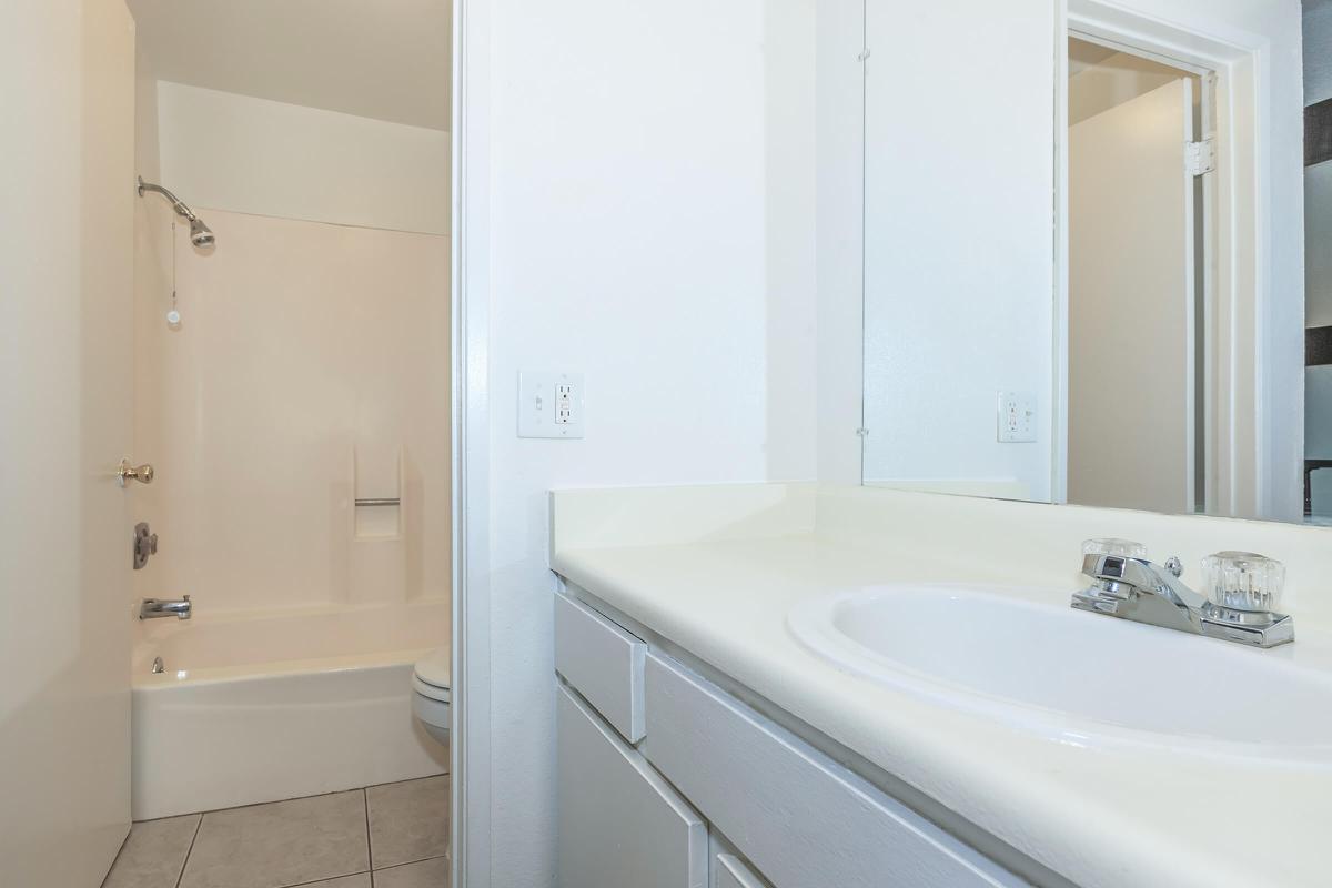 a large white tub sitting next to a sink