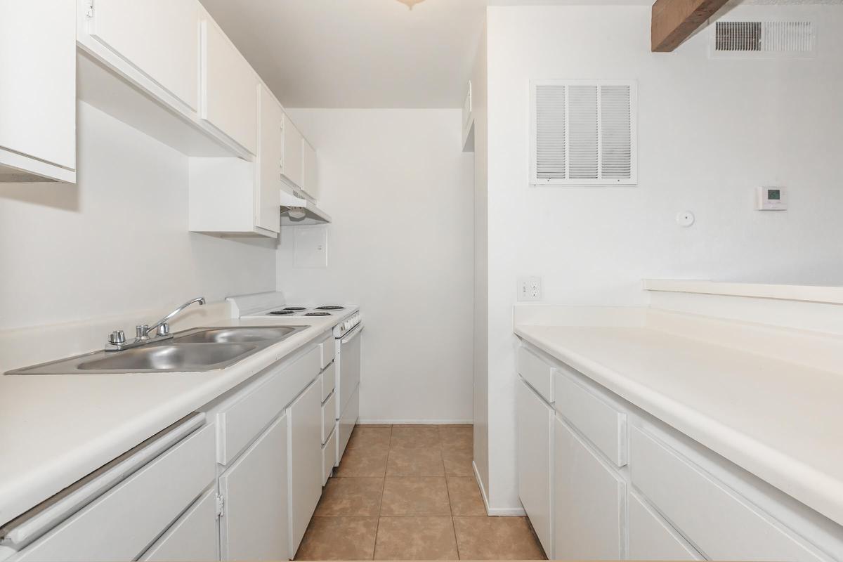 a kitchen with white cabinets and a sink