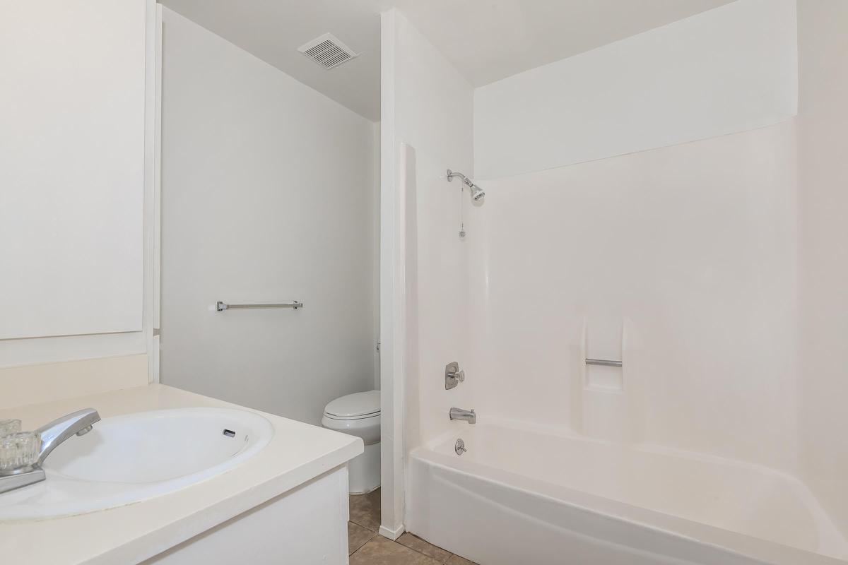 a large white tub sitting next to a sink