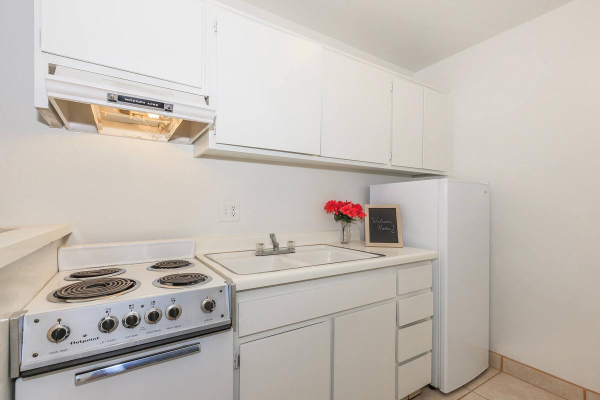 a white stove top oven sitting inside of a kitchen