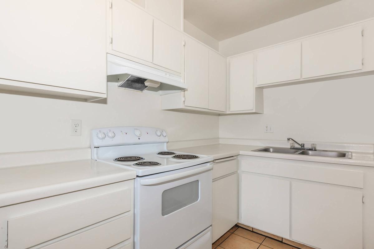 a white stove top oven sitting inside of a kitchen