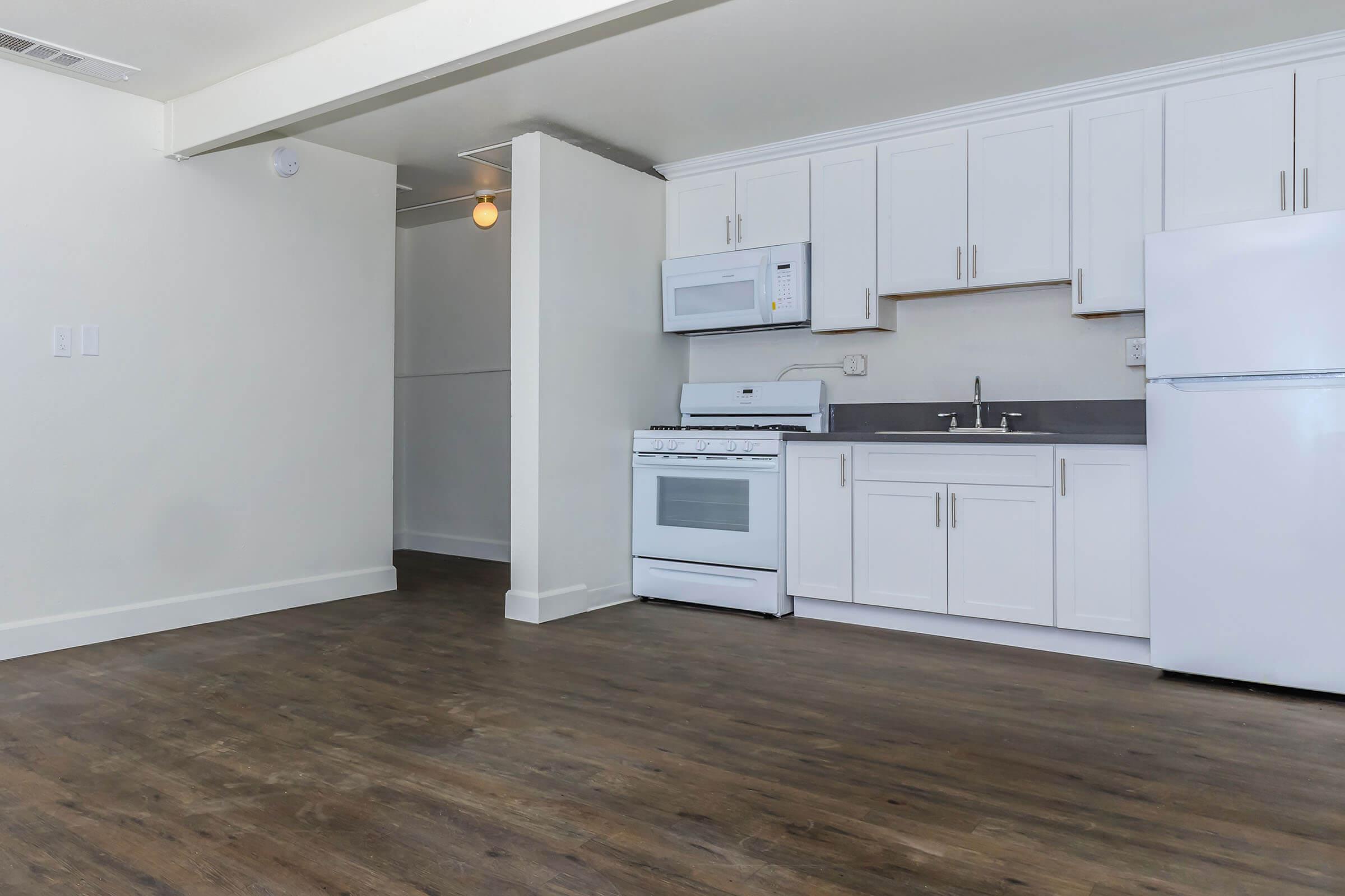 a kitchen with a stove and a refrigerator