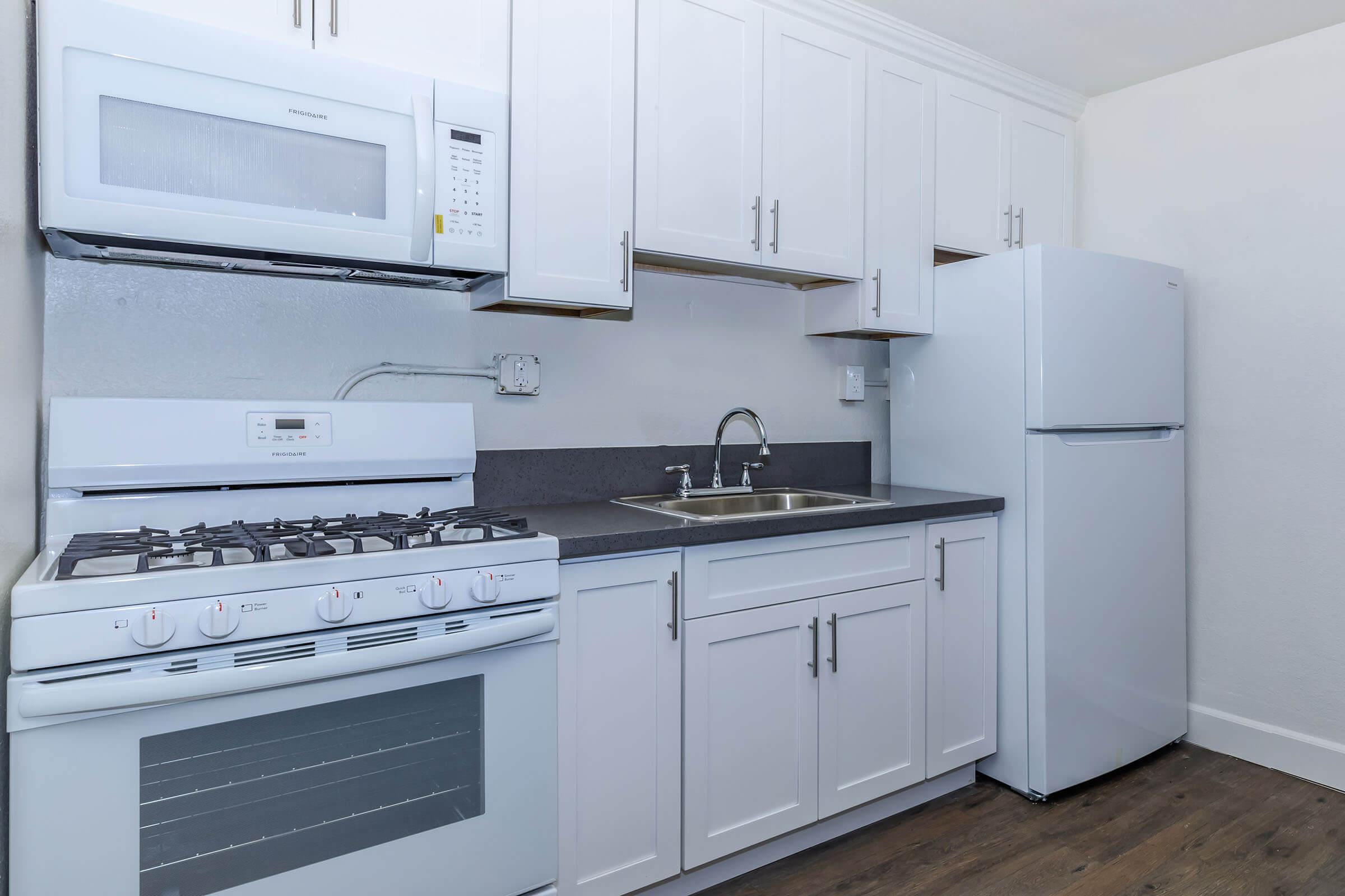 a stove top oven sitting inside of a kitchen