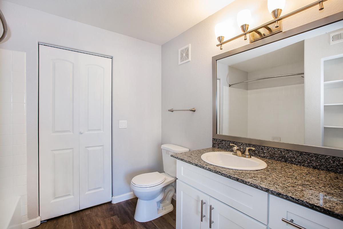 a kitchen with a sink and a mirror