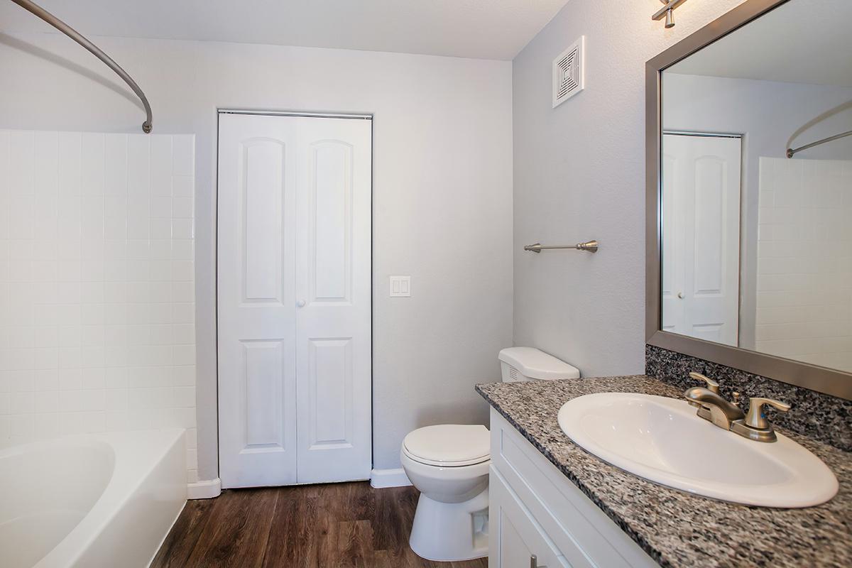 a large white tub next to a sink