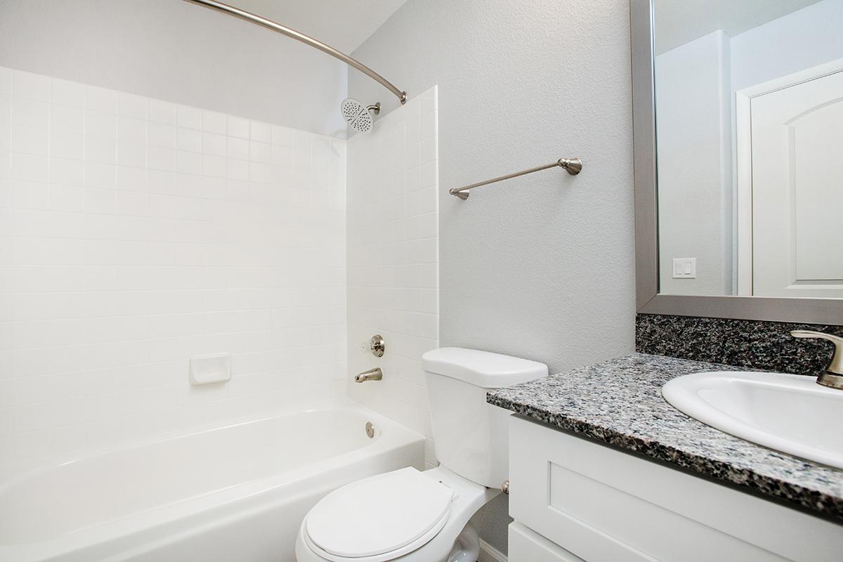 a large white tub next to a sink