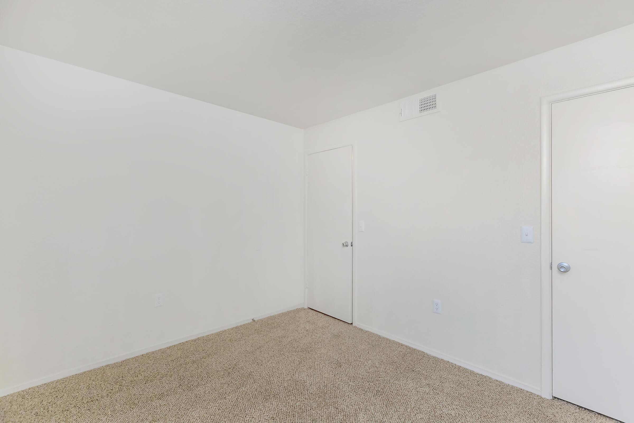 a bedroom with a bed and a mirror