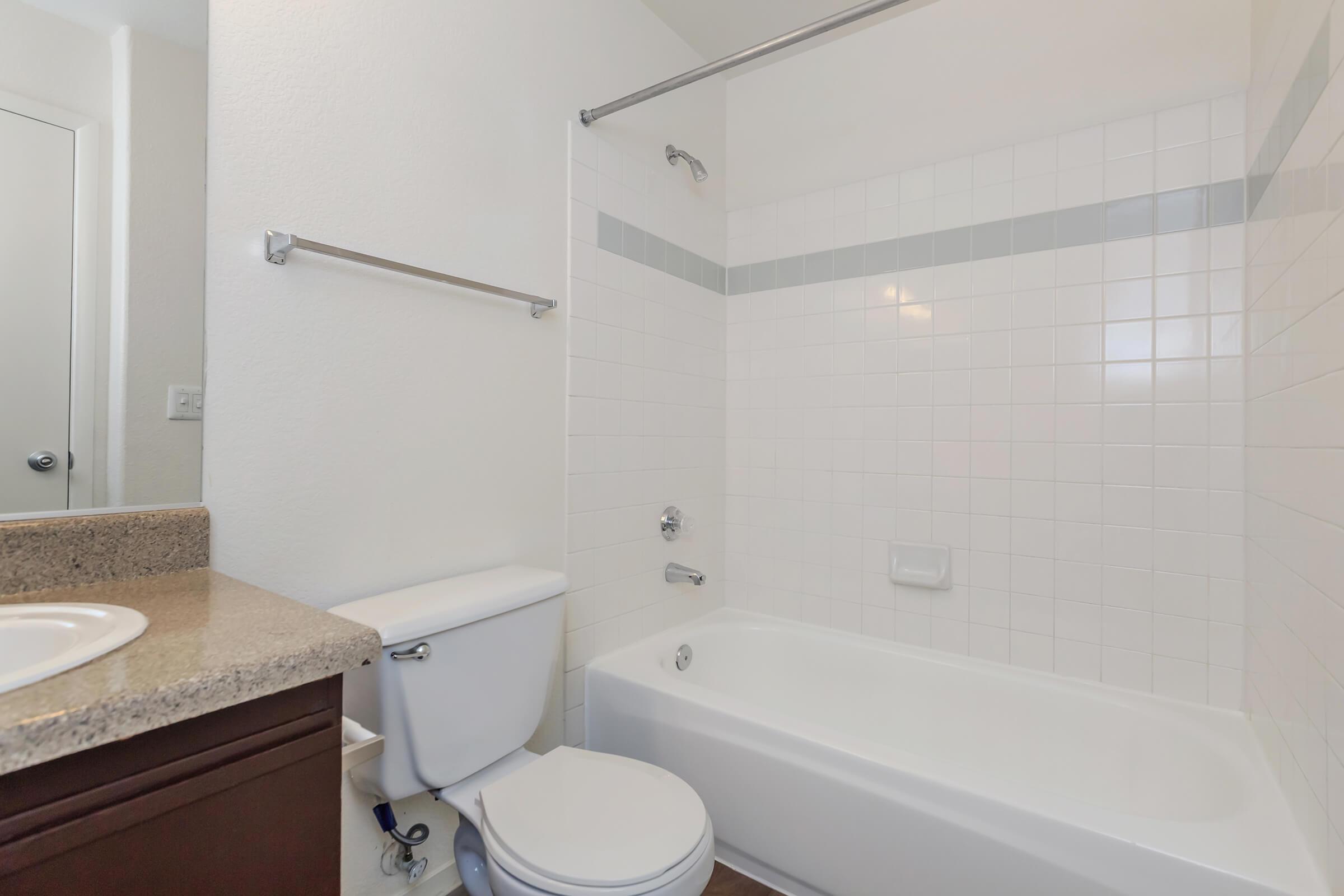 a white tub sitting next to a sink