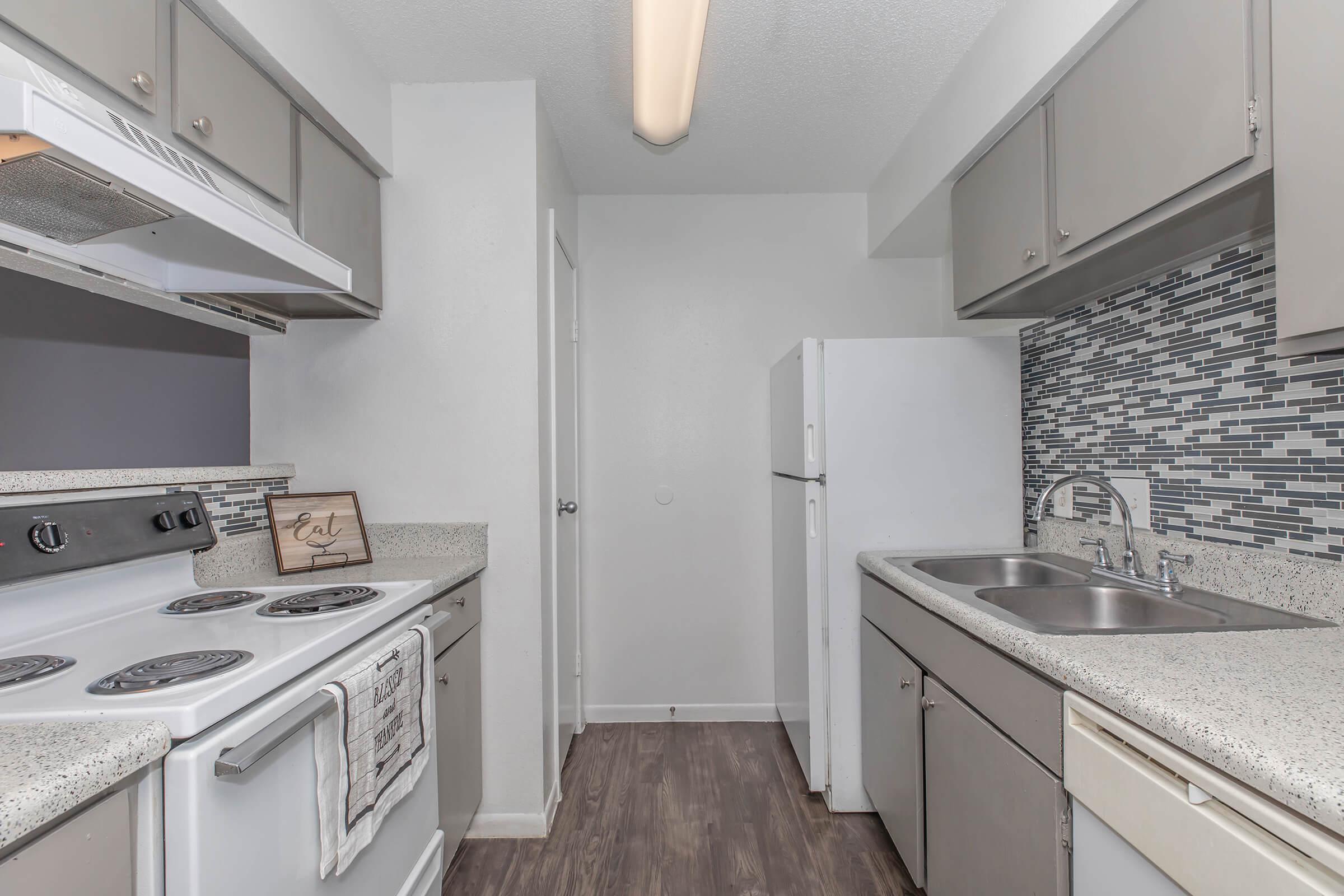 a kitchen with a stove sink and refrigerator