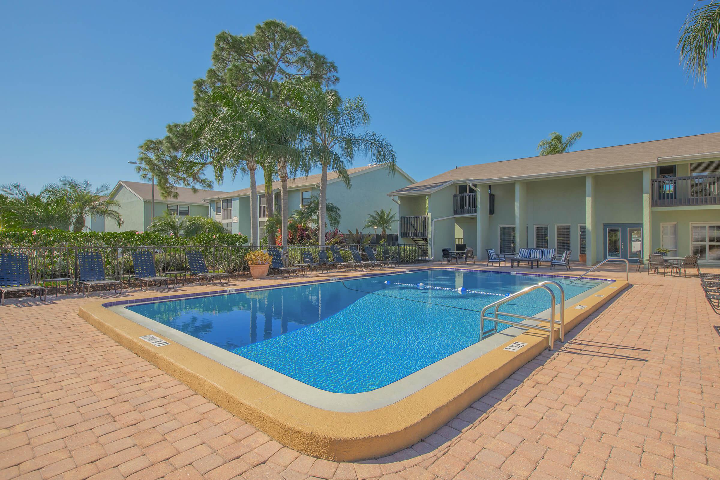 a house with a pool outside of a building