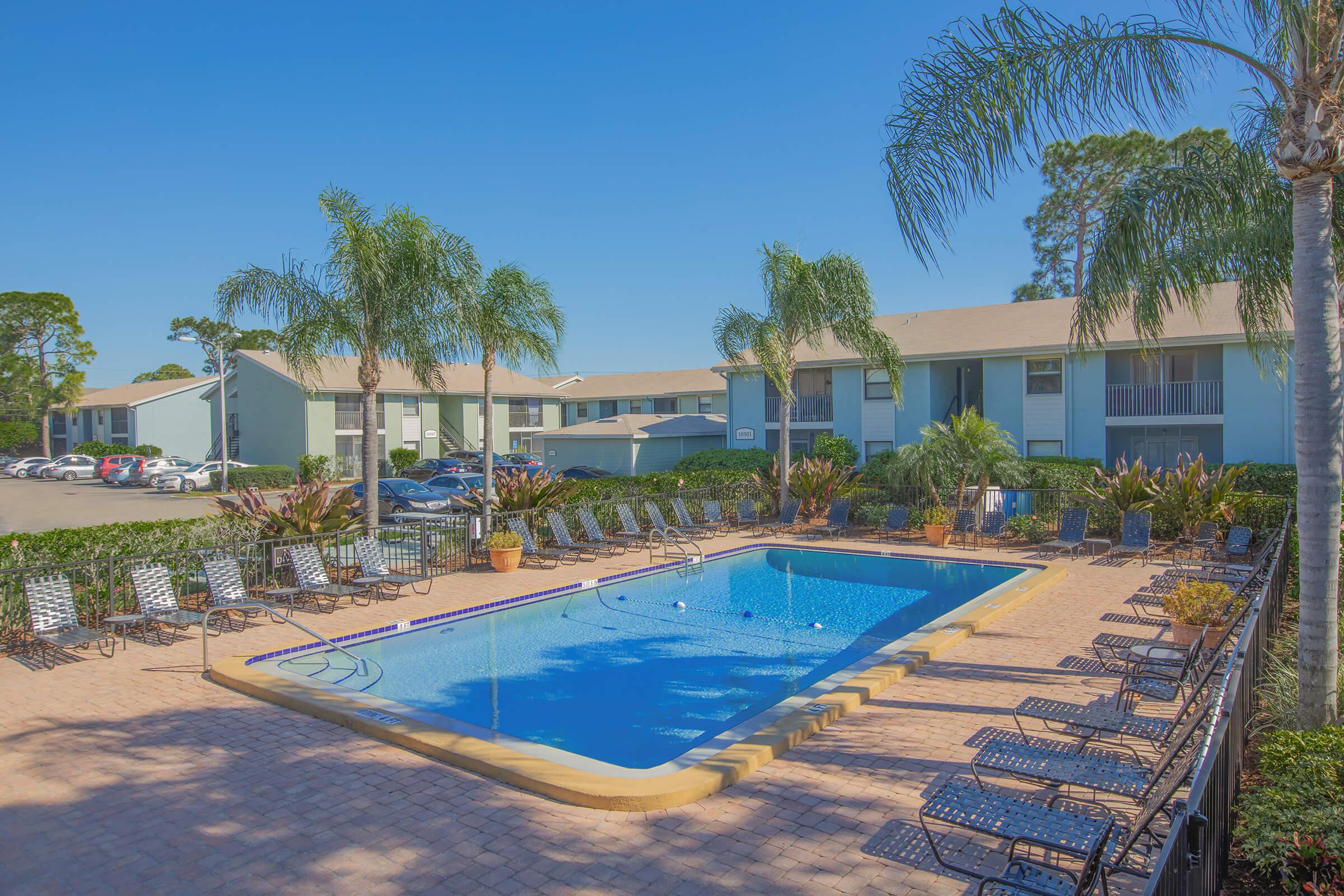 a house with a pool in front of a building