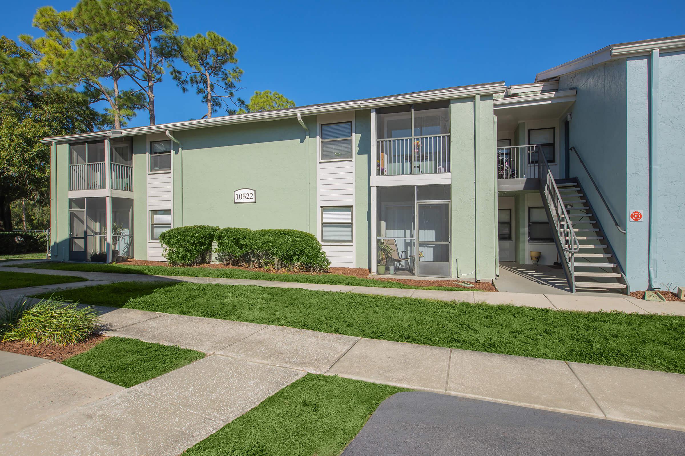 a house with a lawn in front of a building