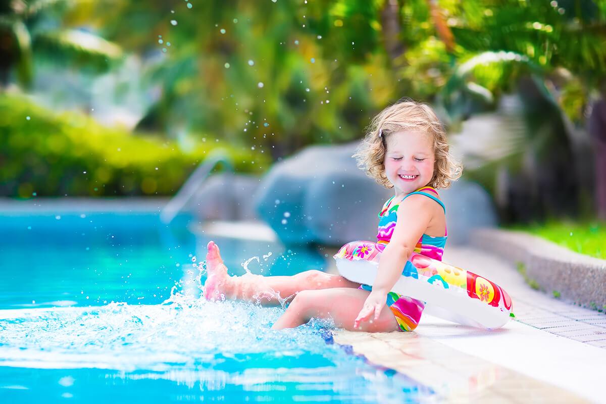 a young girl in a pool of water