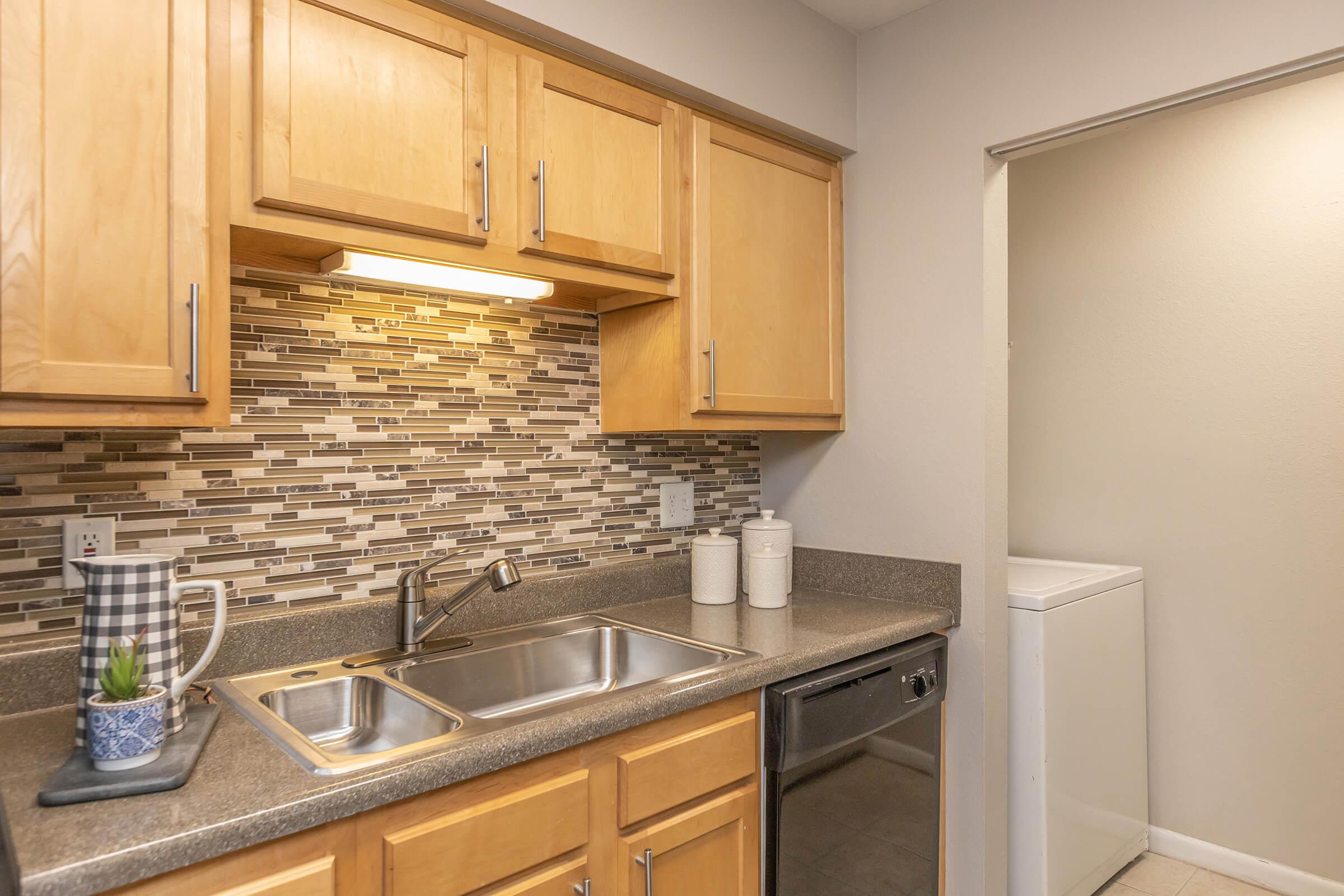 a kitchen with stainless steel appliances and wooden cabinets