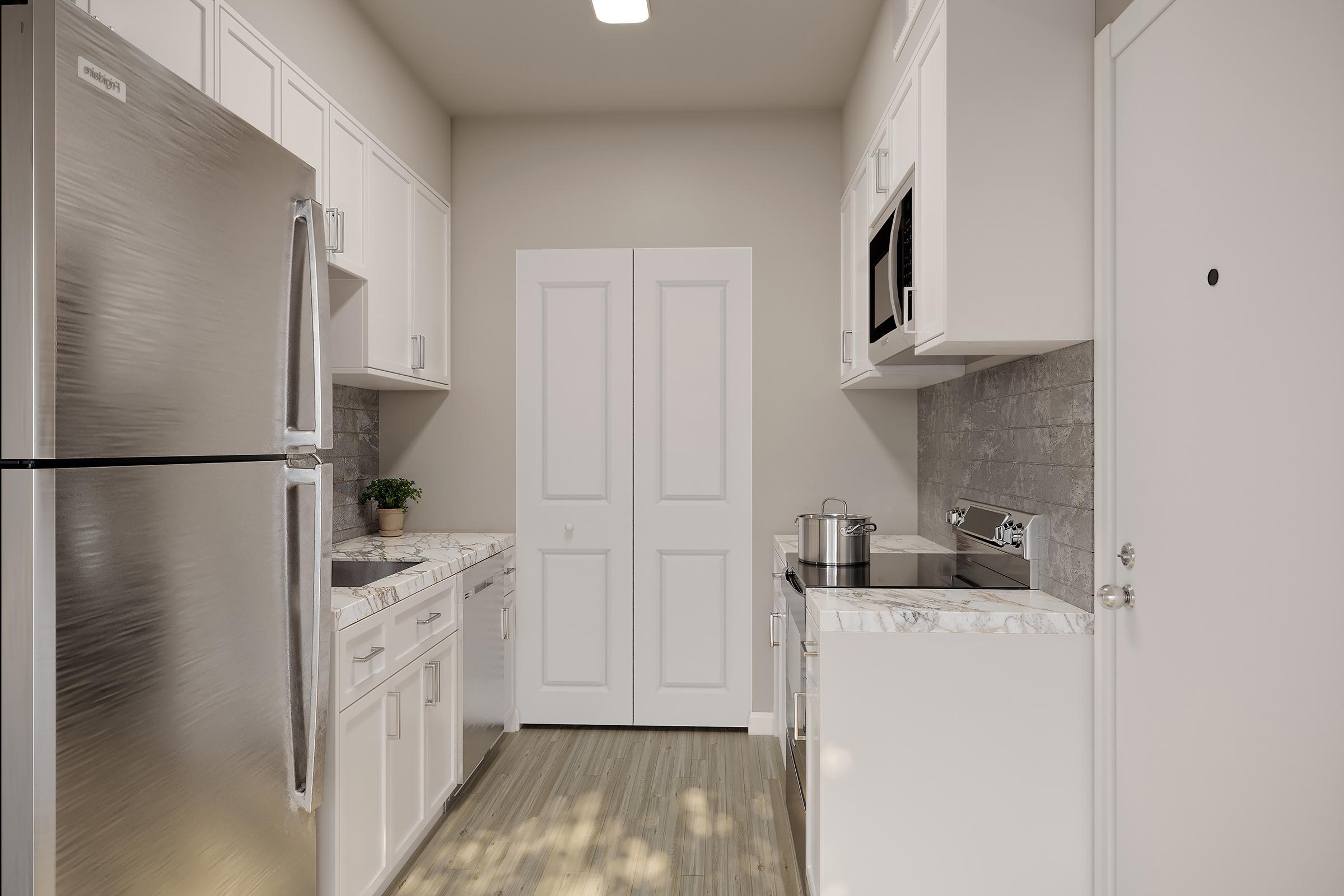 A modern kitchen featuring stainless steel appliances, including a refrigerator and stove. The cabinets are white, with a sleek countertop and a tiled backsplash. A small potted plant adds a touch of greenery, while double doors are seen in the background, leading to a storage or pantry area. The space is bright and inviting.