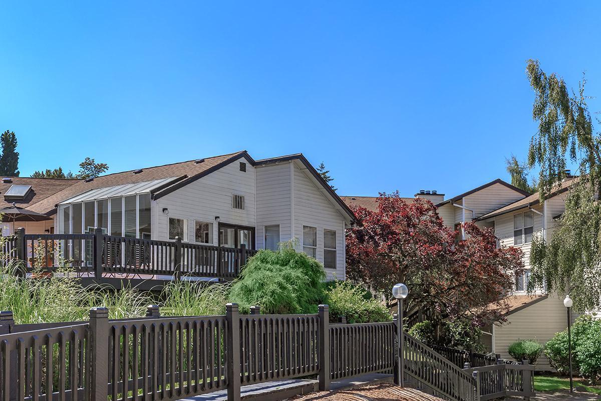 a house with a fence in front of a building